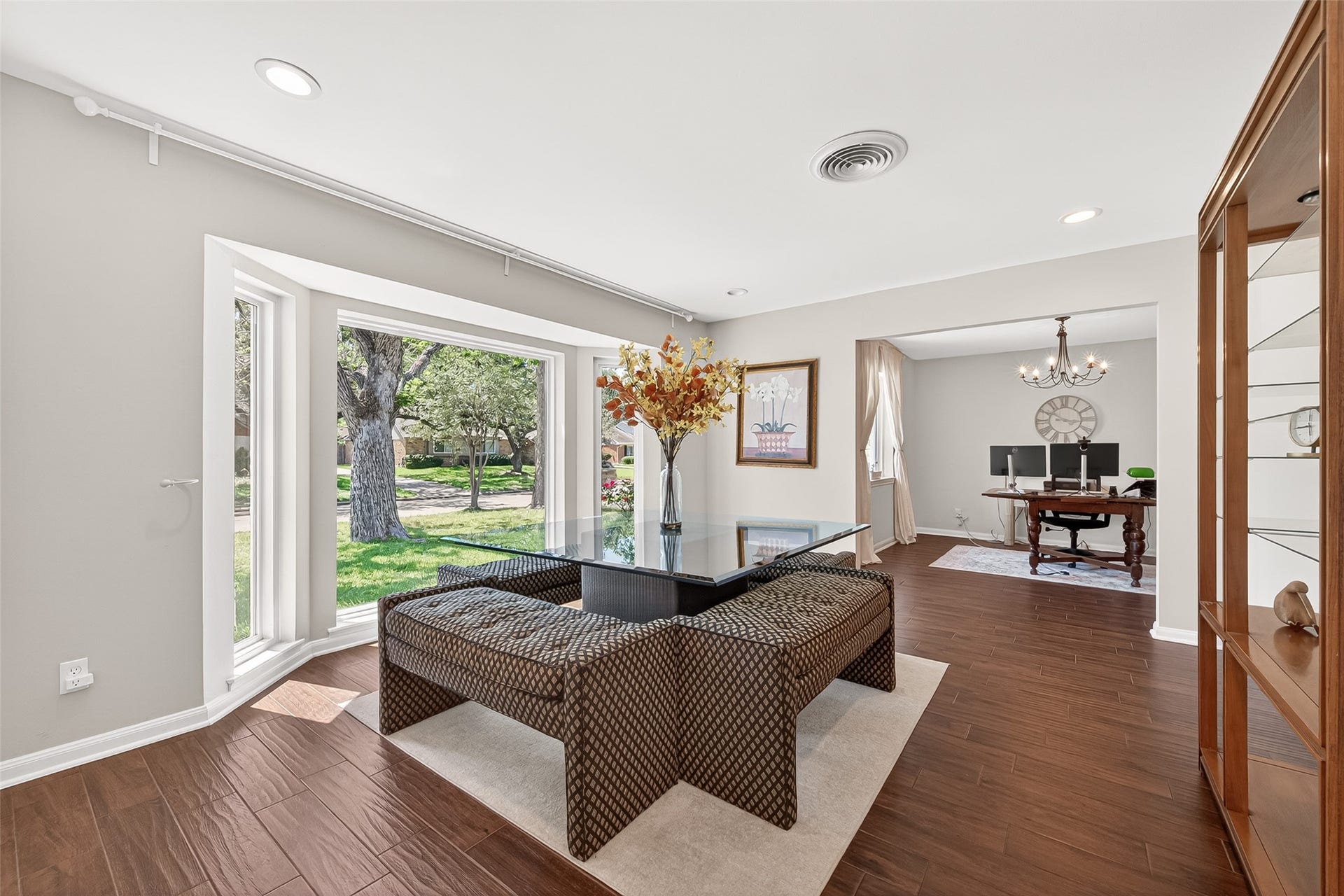 2610 Teague Road, Houston, TX 77080 Elegant formal living room positioned at the front of the home, featuring large bay windows that flood the space with natural light and create a warm, inviting atmosphere perfect for entertaining or everyday living.