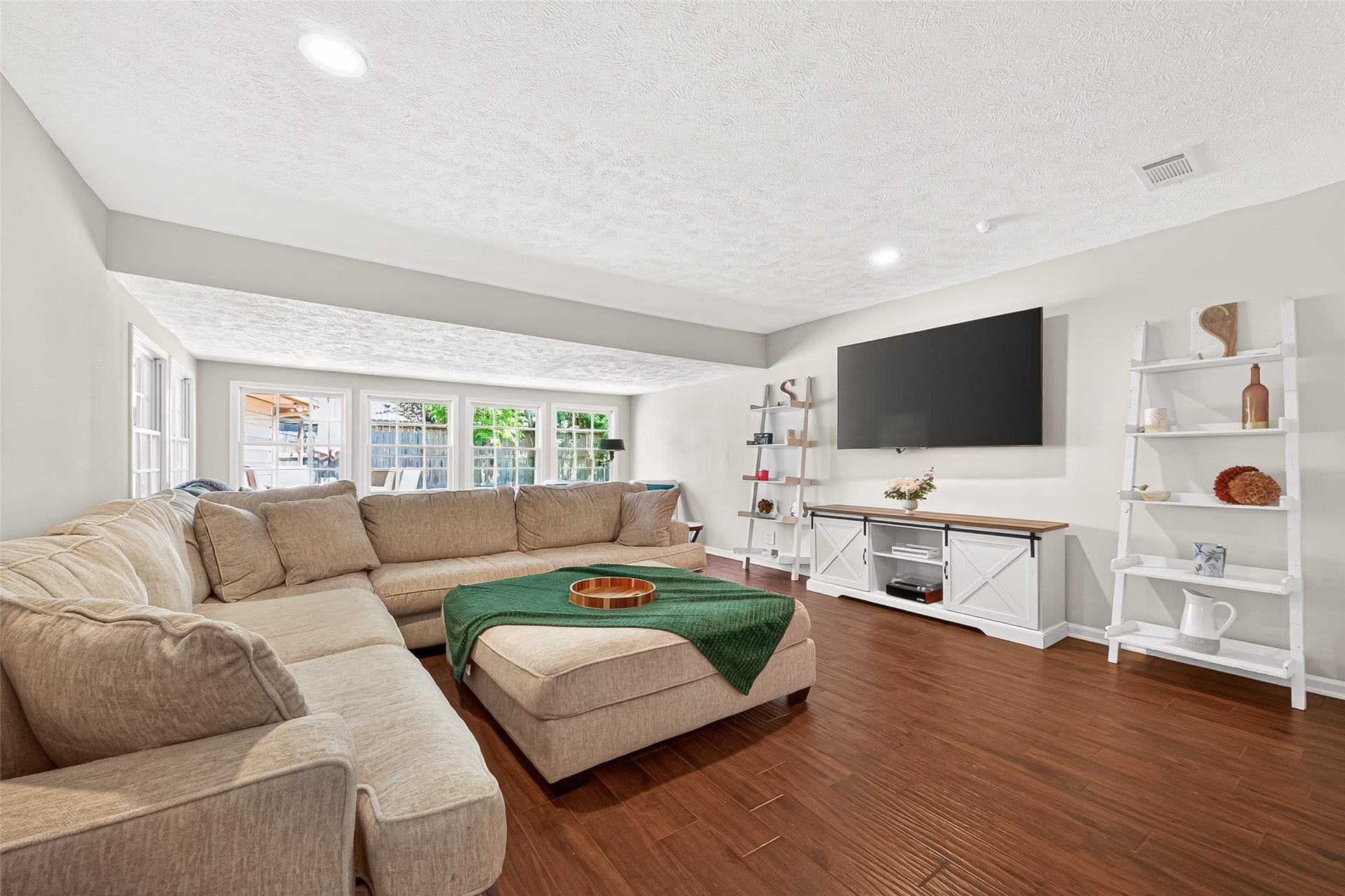 2610 Teague Road, Houston, TX 77080 Spacious family room featuring a stunning wall of windows that fills the space with abundant natural light and offers an open, airy feel ideal for relaxing or gathering with family and friends.