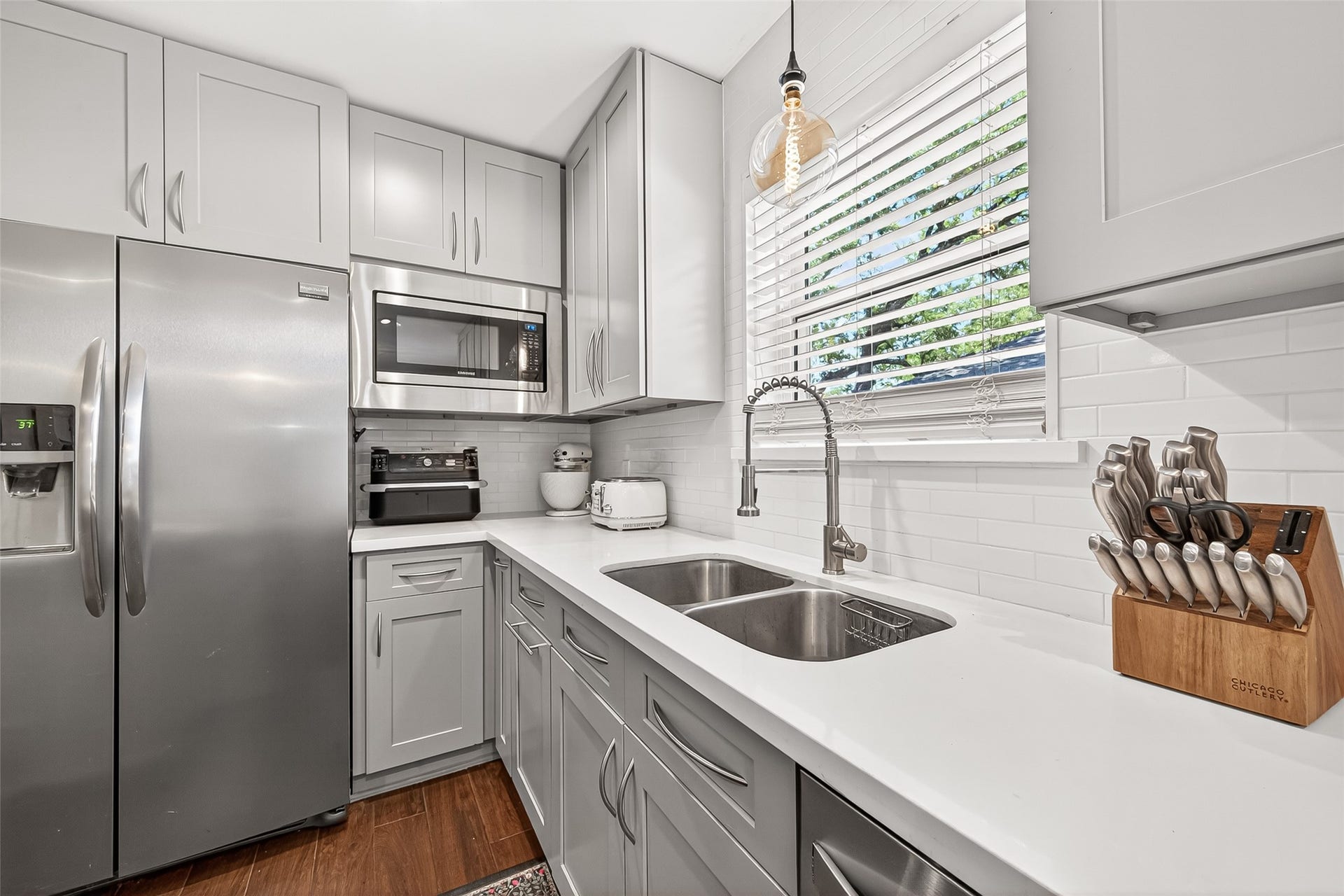 2610 Teague Road, Houston, TX 77080 Well-appointed kitchen featuring abundant cabinetry and storage, stainless steel appliances, and an abundance of natural light that enhances the bright, welcoming atmosphere.