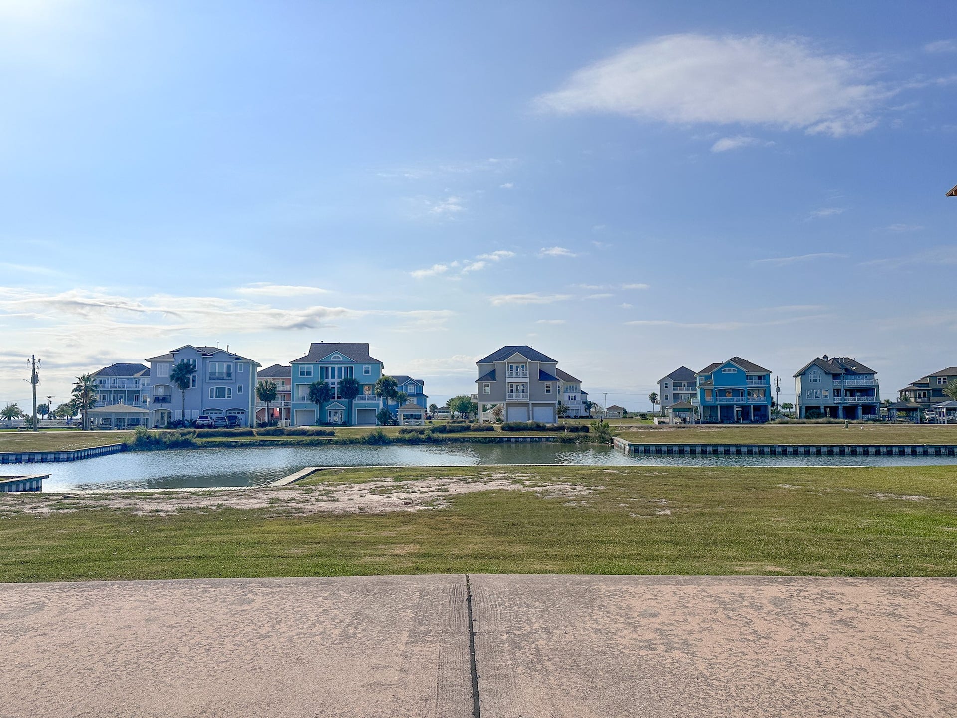 7 Big Torch, Hitchcock, TX 77563 Street view showcasing the homesite to the right, the future boat dock area to the left, and the beautiful landscaped preserve directly across the canalwhere no homes can be built, helping preserve your peaceful view.