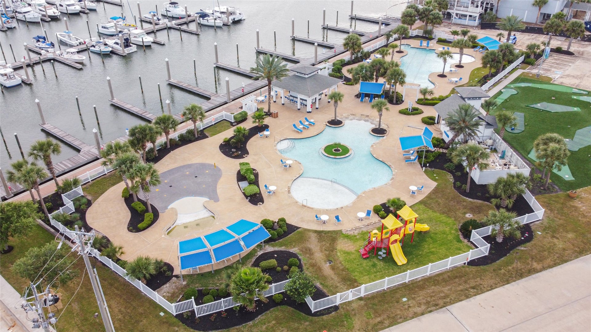 7 Big Torch, Hitchcock, TX 77563 The Harborwalk community offers an impressive variety of amenities, including this entertainment area with two pools, a splash pad, pool bar, playground, and putt-putt golf course beside the full-service 156-slip marina with a ship store, fuel, bait shop, deli, boat ramp, lodge, and event center.