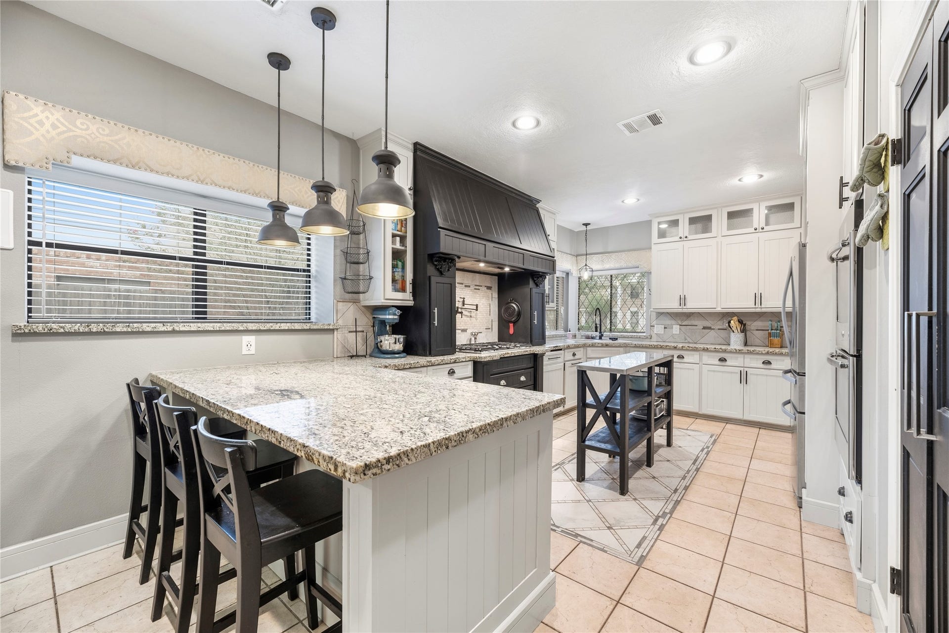 Huge breakfast bar with pendant lighting.