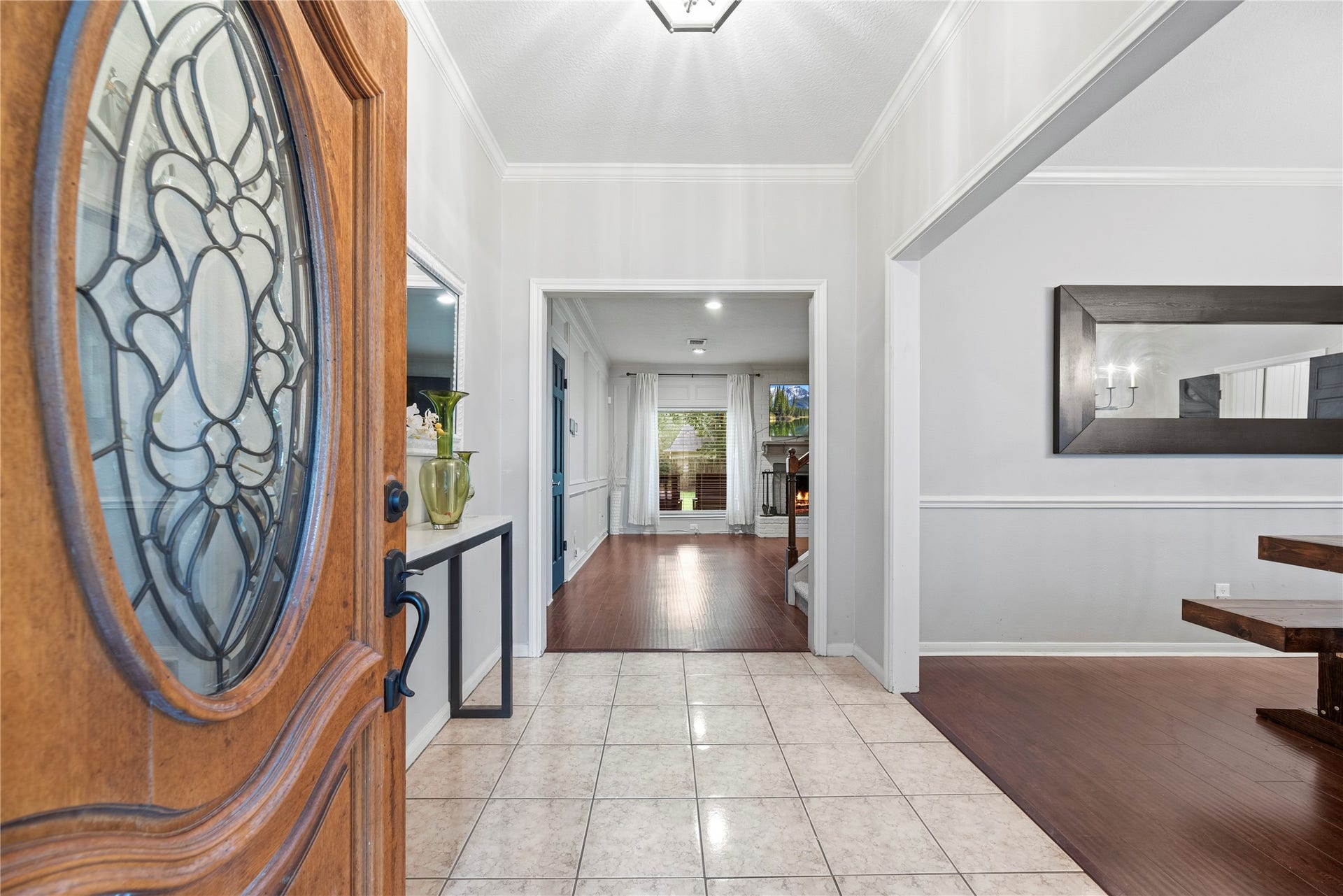 Inviting front entry with tile flooring and crown molding.