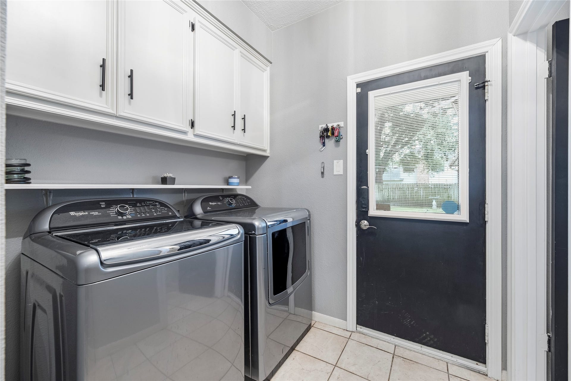 Laundry room with additional storage.