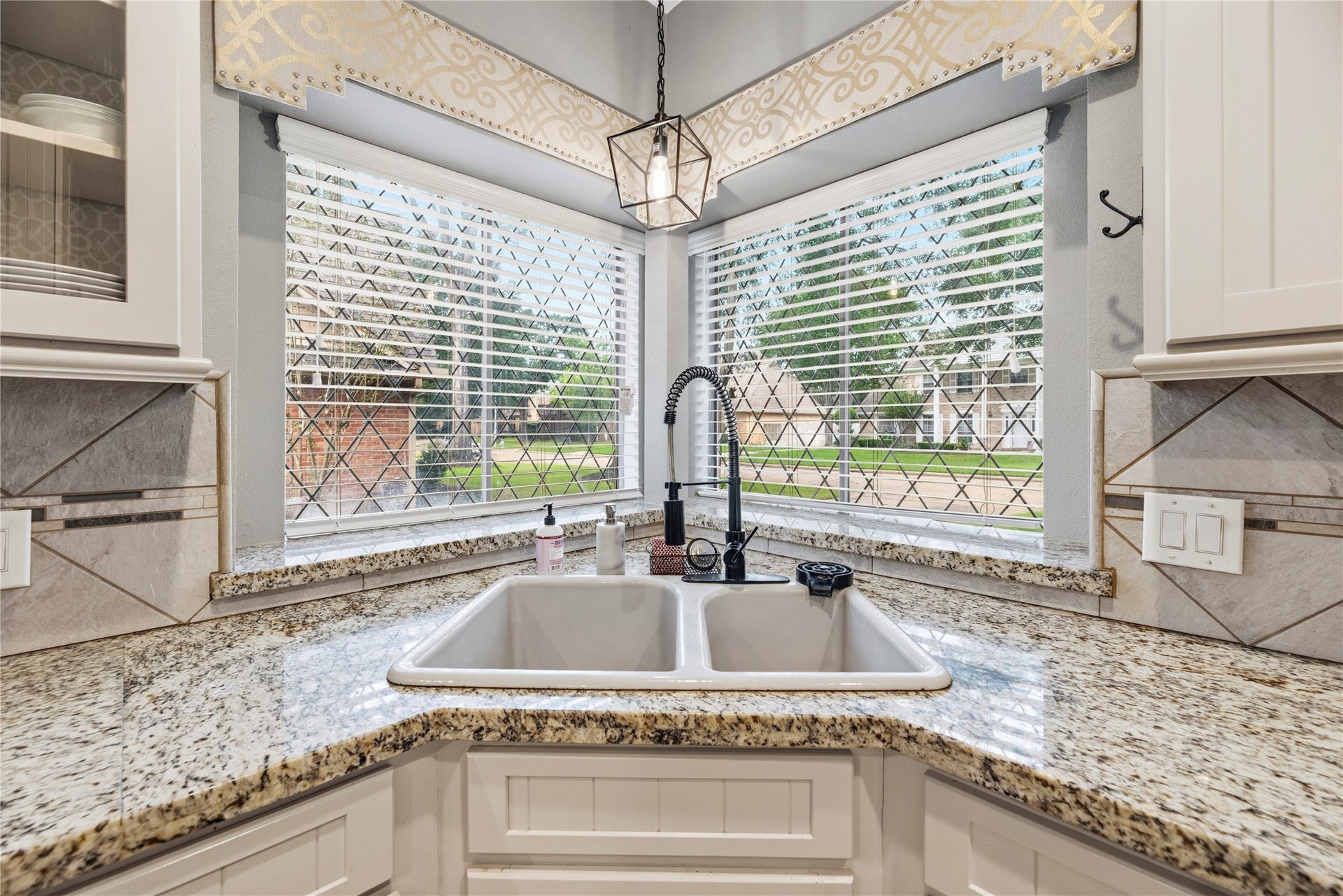Windows above the corner sink provide natural lighting.