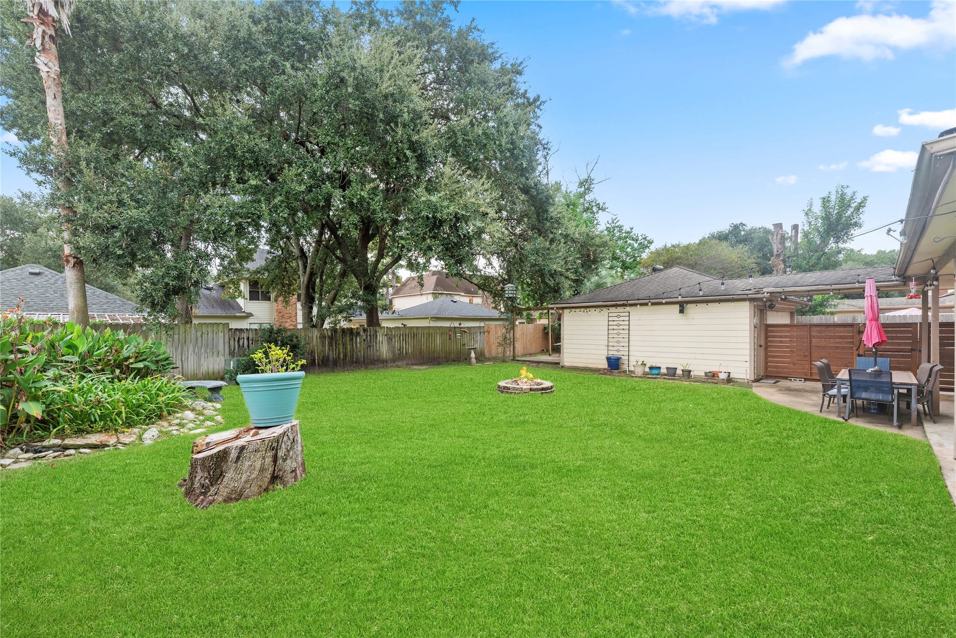 Private backyard with a covered patio and firepit.