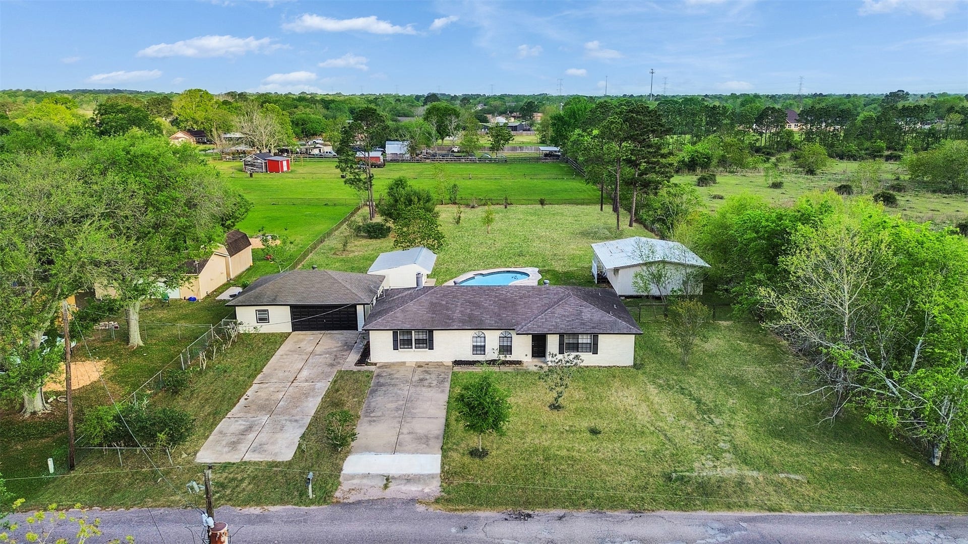 1905 County Road 235, Alvin, TX 77511 This home has an oversized drive through garage, with a detached structure and extra storage space!