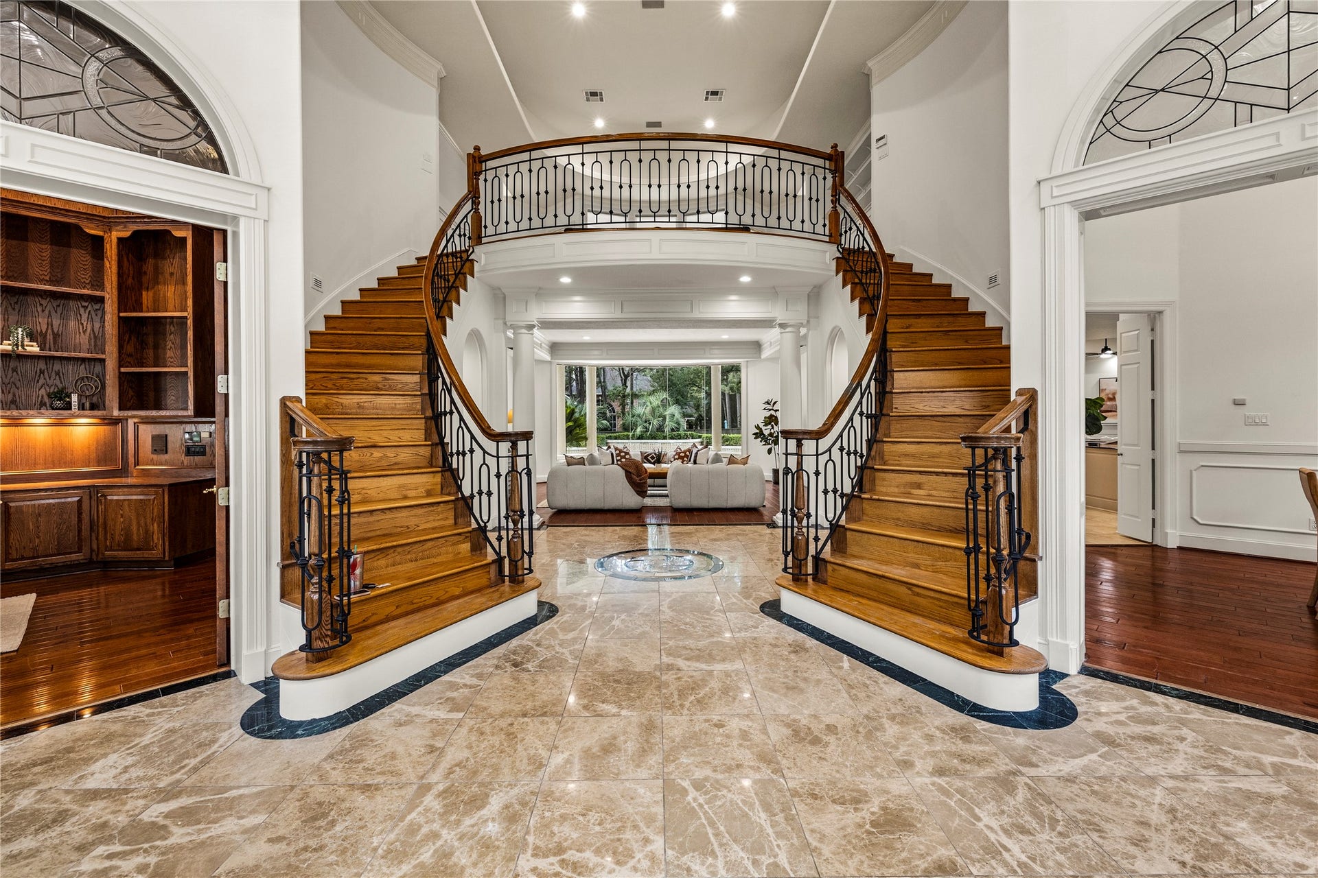 Two sweeping stair cases with rodunda show casing the 2 story entryway. Truly an entry that is unforgettable.