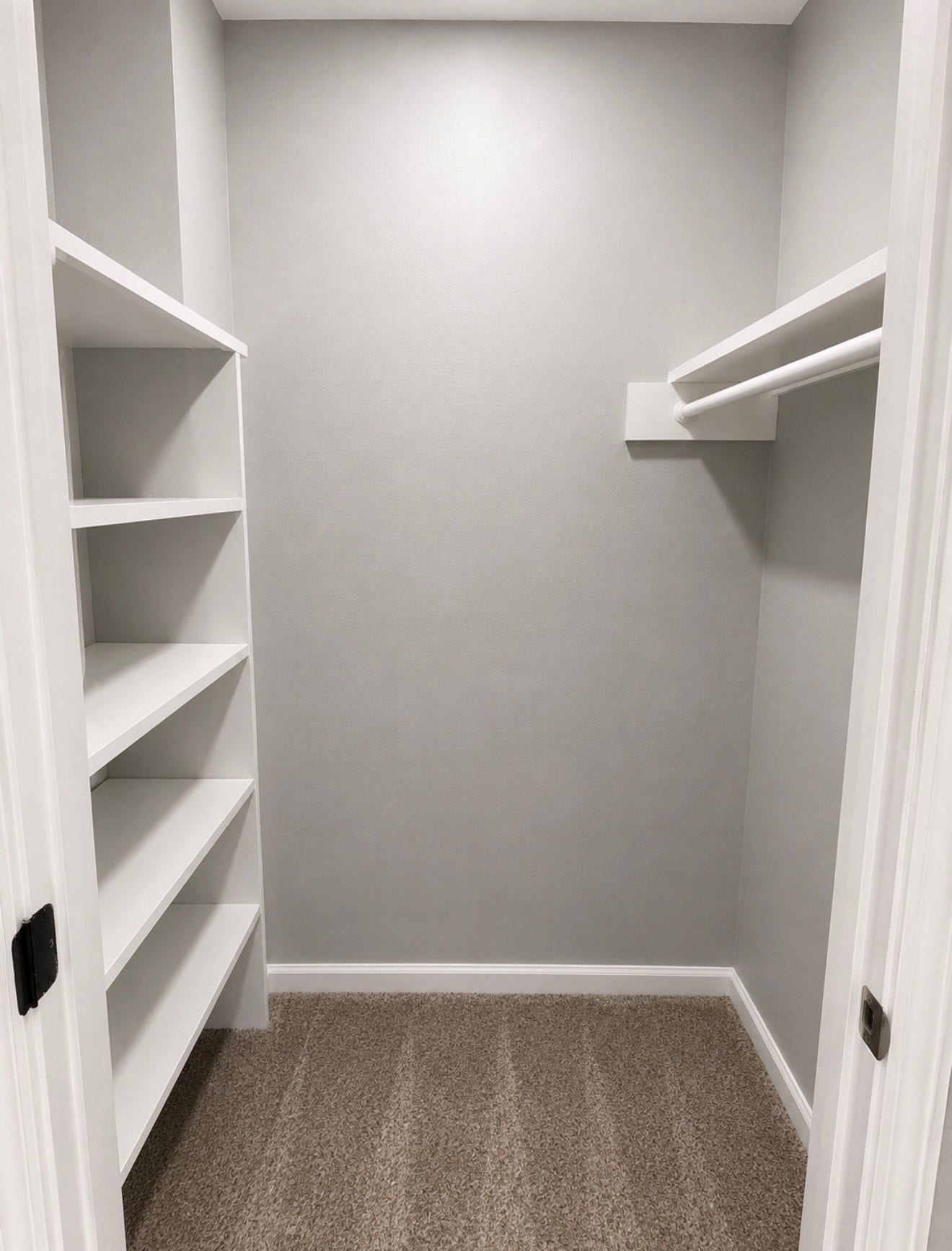Massive walk-in storage closet for games or holiday decor at top of stairs.