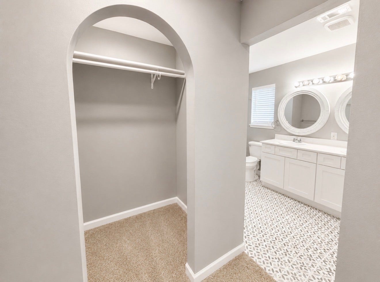 His and hers closets on each side of hallway leading to upstairs primary bathroom.