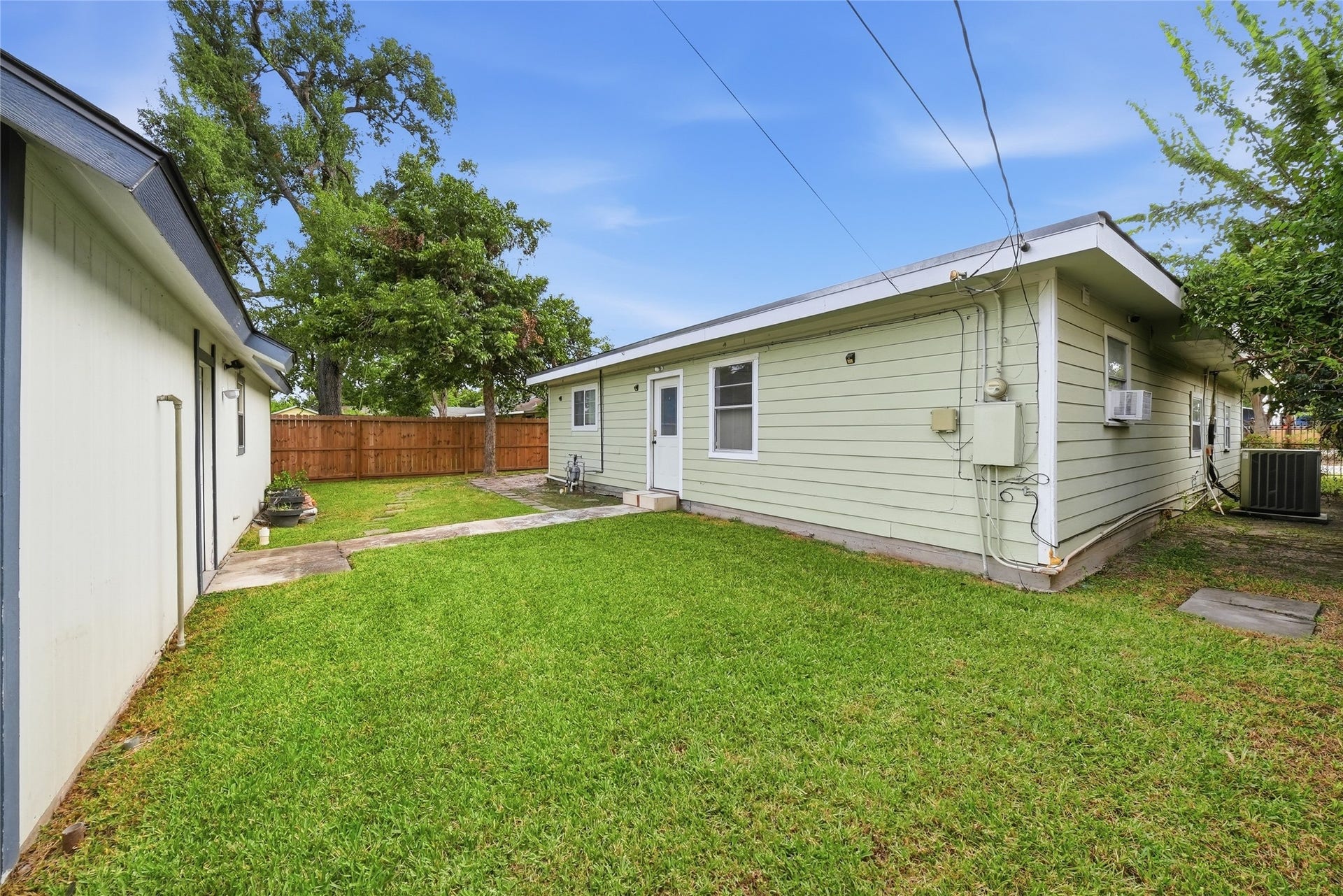 Charming backyard with a well-maintained lawn and a privacy fence, perfect for outdoor activities and relaxation.