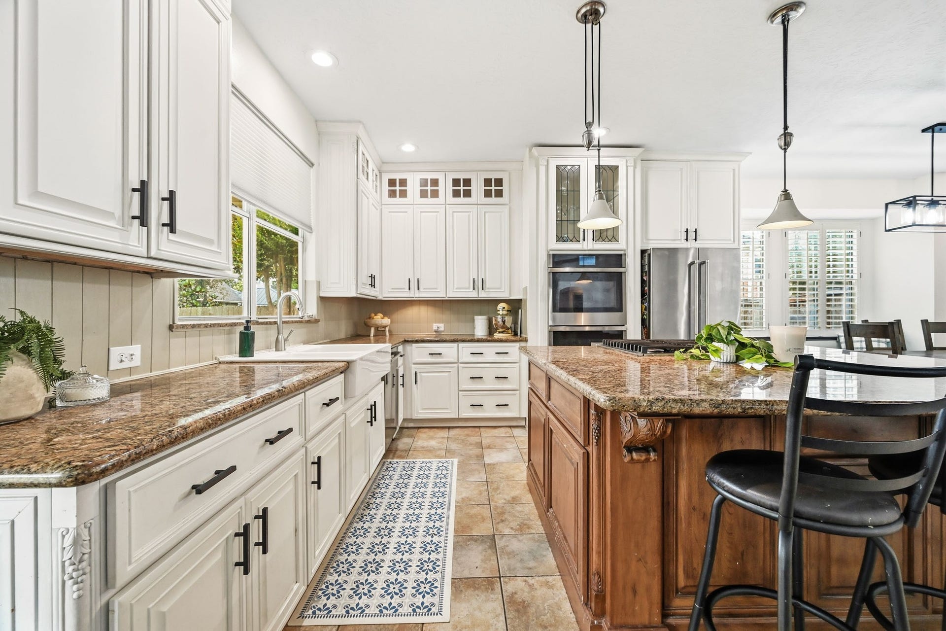 3807 Oakland Circle, Missouri City, TX 77459 Kitchen is equipped with Updated cabinetry, farmhouse sink, oversized island, granite counters, stainless appliances & double ovens