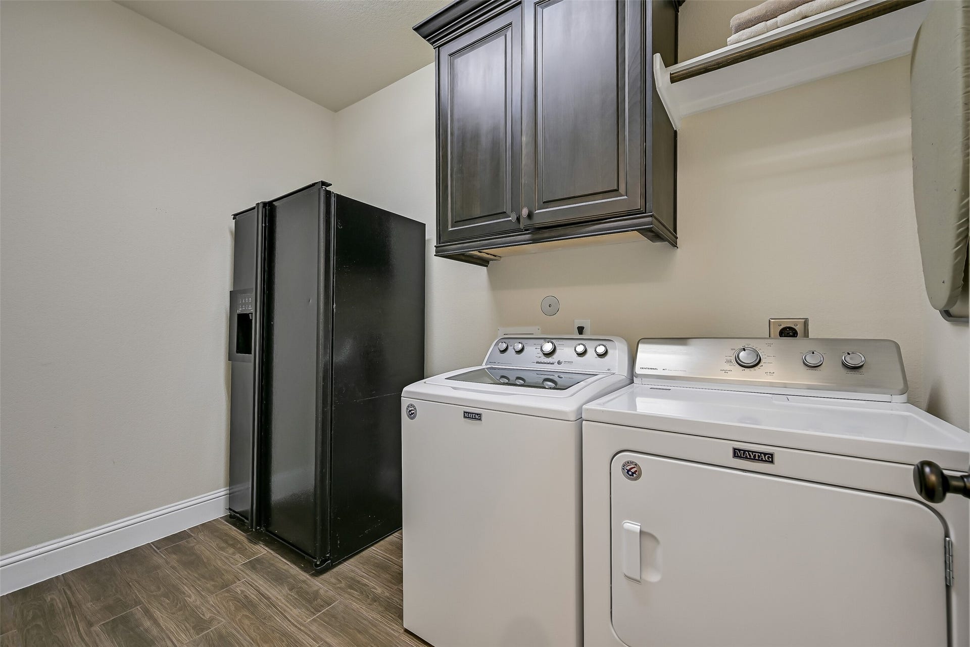 1645 Longwood Glen Lane, Friendswood, TX 77546 Conveniently located just off the kitchen, the spacious utility room offers upper cabinetry, gas and electric dryer connections, and dedicated space for an additional refrigerator or freezerproviding everyday functionality with extra storage where it matters most.
