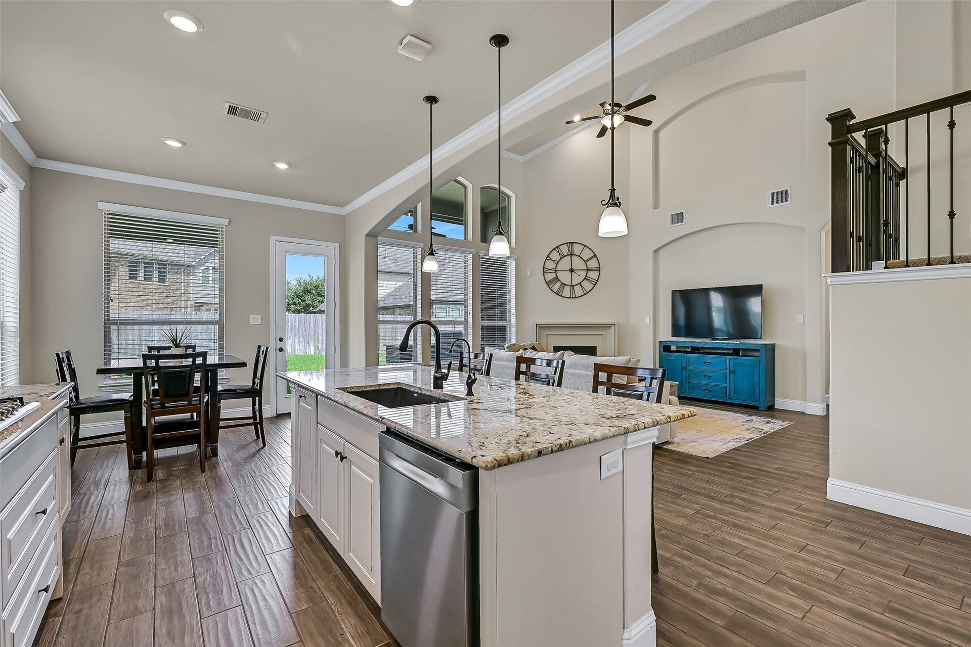 1645 Longwood Glen Lane, Friendswood, TX 77546 The open-concept design truly shines from the kitchen, where an oversized granite island overlooks the breakfast area and dramatic two-story family room. Whether preparing dinner, helping with homework, or hosting friends, this thoughtfully designed space keeps everyone connected while enjoying beautiful backyard views.