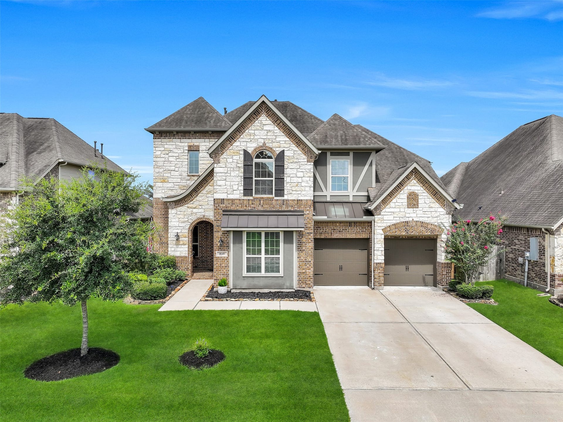 1645 Longwood Glen Lane, Friendswood, TX 77546 From every angle, this beautifully maintained home showcases timeless curb appeal with a striking blend of brick, stone, stucco, decorative wood accents, carriage-style garage doors, and professionally manicured landscaping maintained by a remote controlled sprinkler system. Nestled in sought-after West Ranch and zoned to Friendswood ISD, it's a home you'll be proud to come home to.