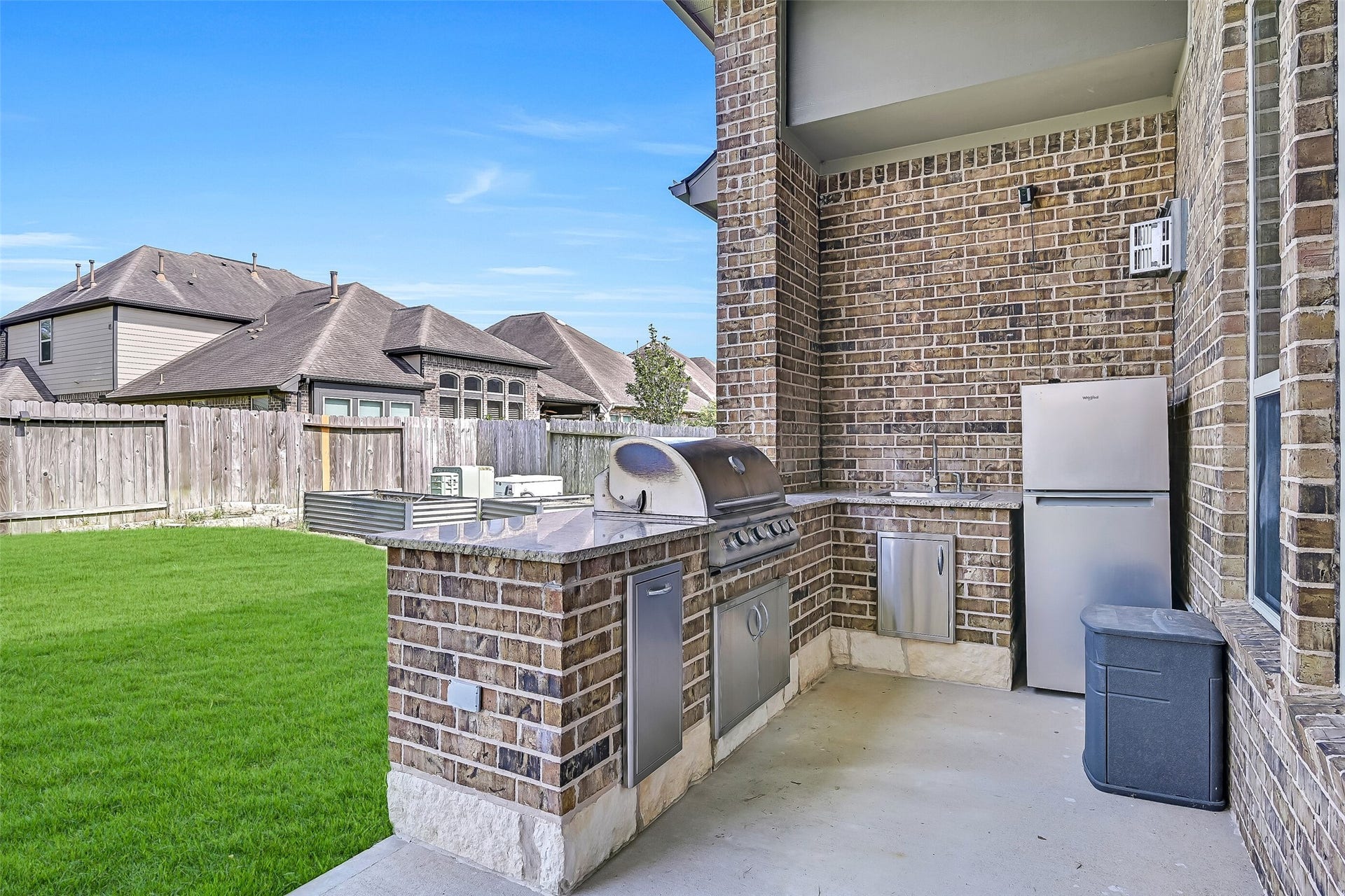 1645 Longwood Glen Lane, Friendswood, TX 77546 Weekend cookouts are effortless with the covered outdoor kitchen featuring granite countertops, a built-in 5 burner gas grill, sink, refrigerator, pull out trash, and convenient storage. Everything you need is right at your fingertips while overlooking the spacious backyard.