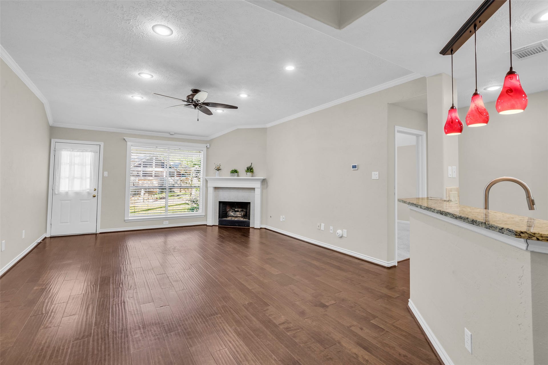 14 Almond Branch Place, The Woodlands, TX 77382 Gas fireplace. Door to Primary Suite shown on the right side