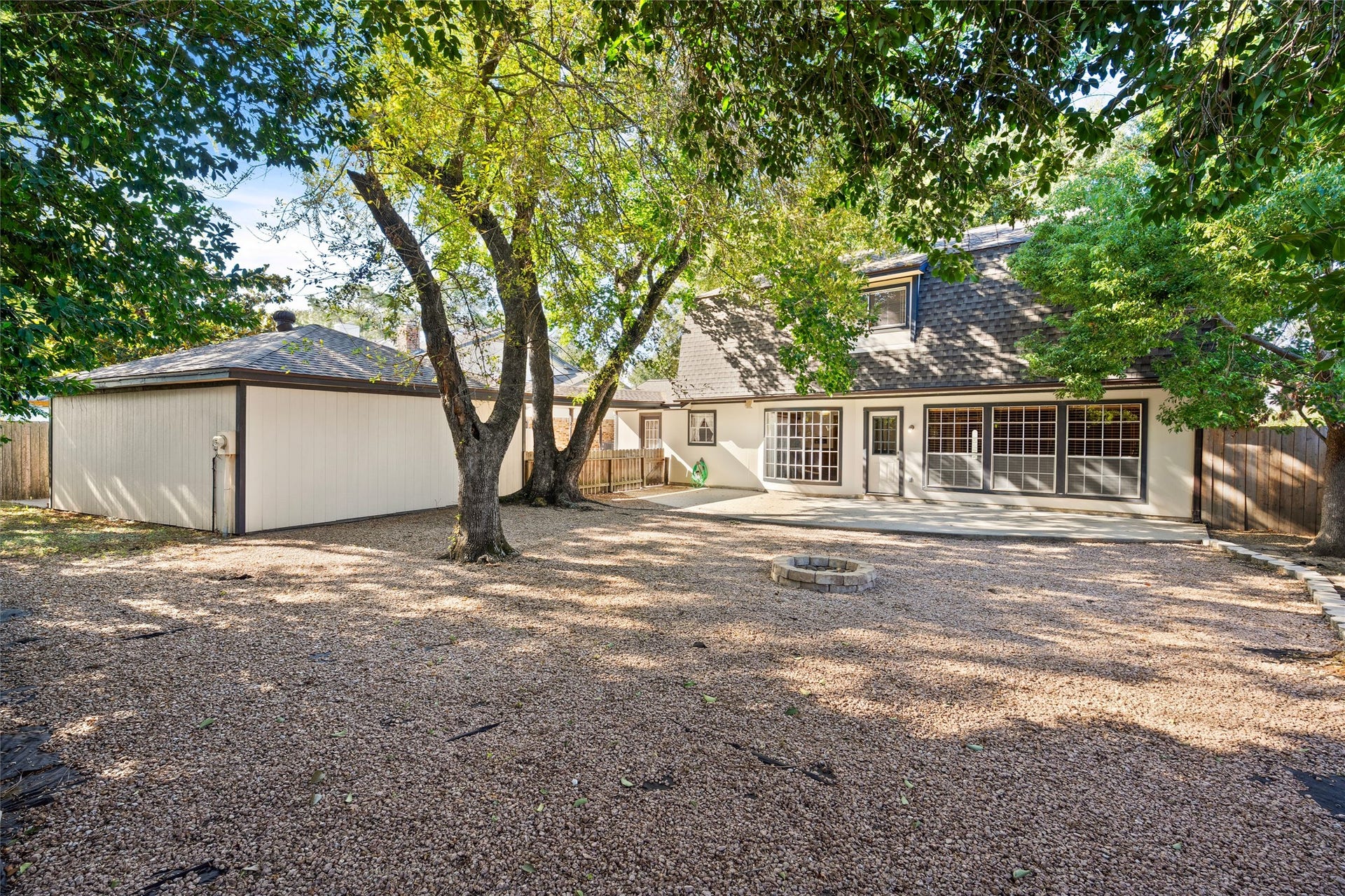 The backyard is easily maintained flanked only by flowerbeds and a large green space behind the detached garage.