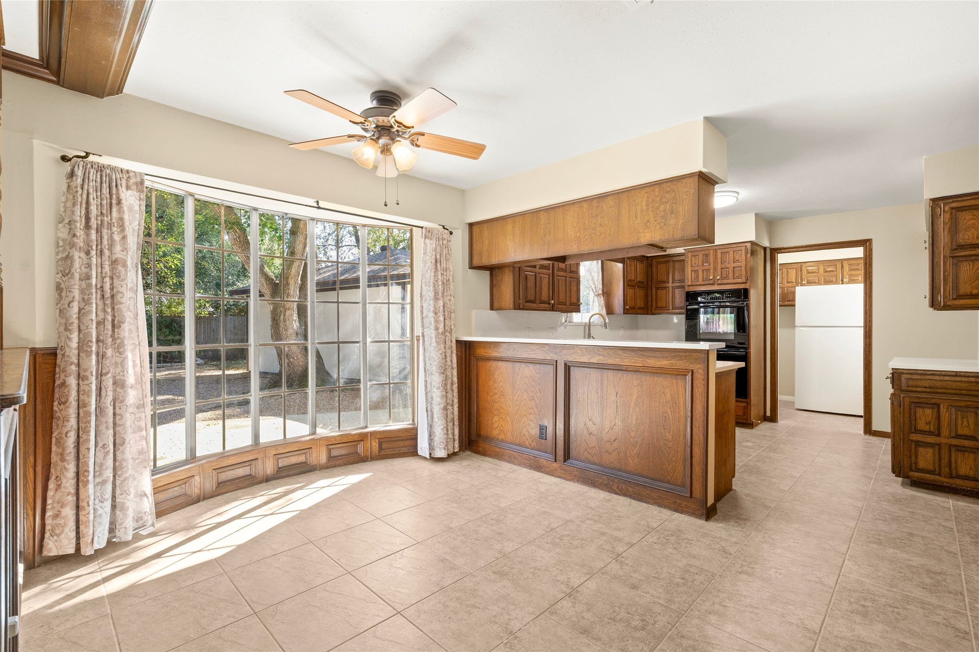 Bright breakfast nook with floor to ceiling windows.