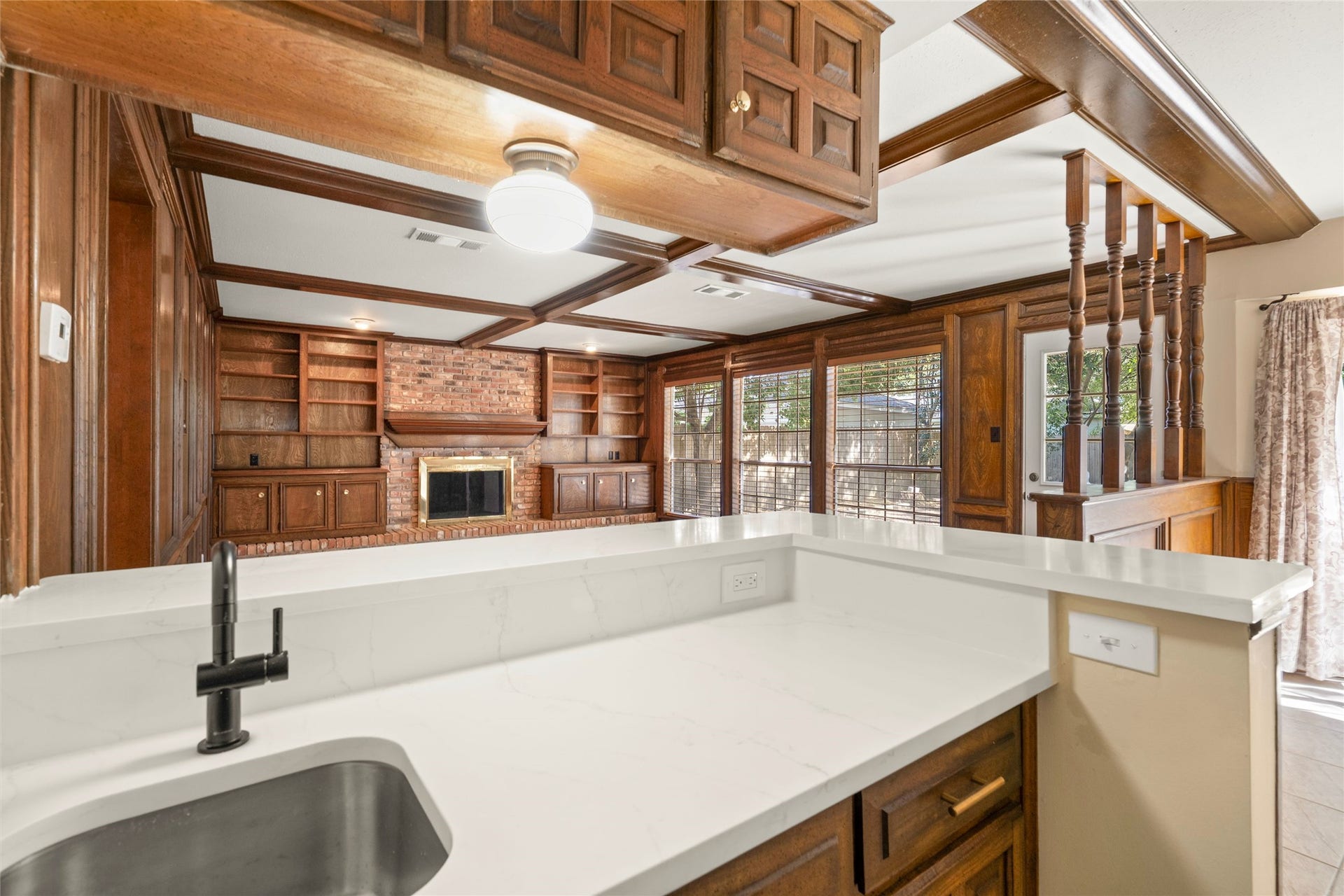 View from the wet bar into the family room and out to the outdoor patio area that can be seen from this location.