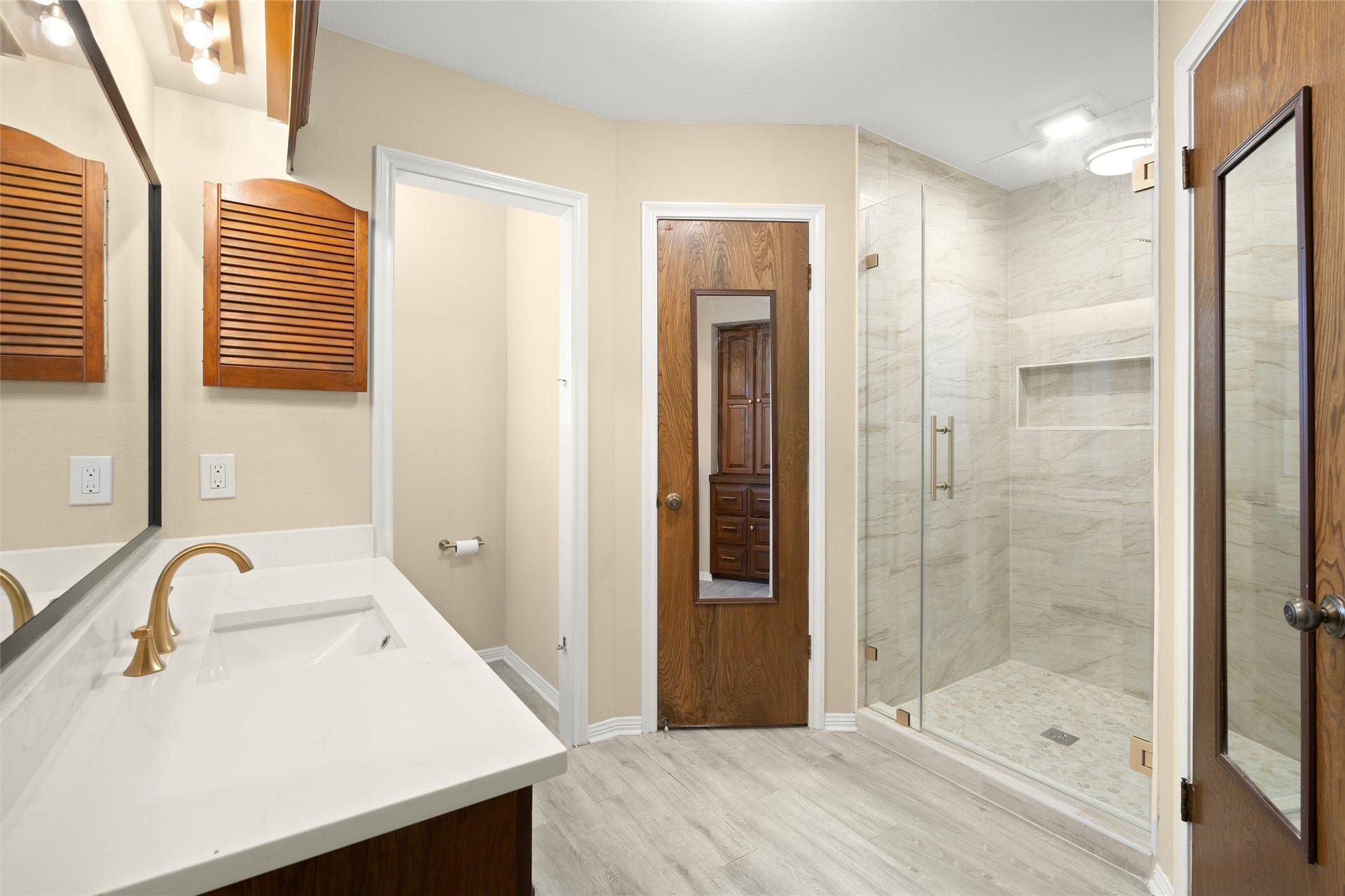 The primary bath has been updated with quartz countertops and new fixtures.