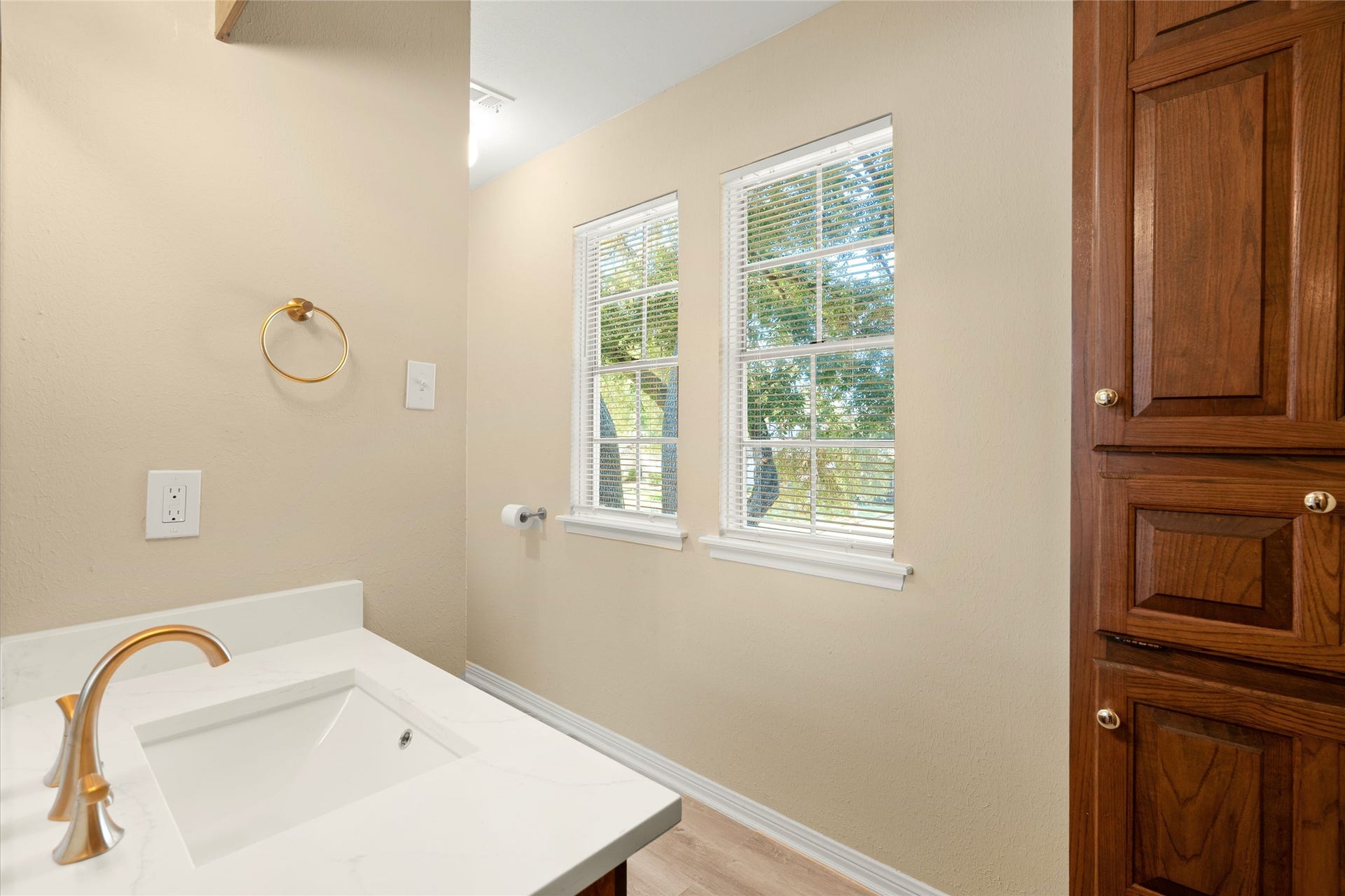 Windows in the 2nd bath provide natural light. There's also a linen close with storage options.