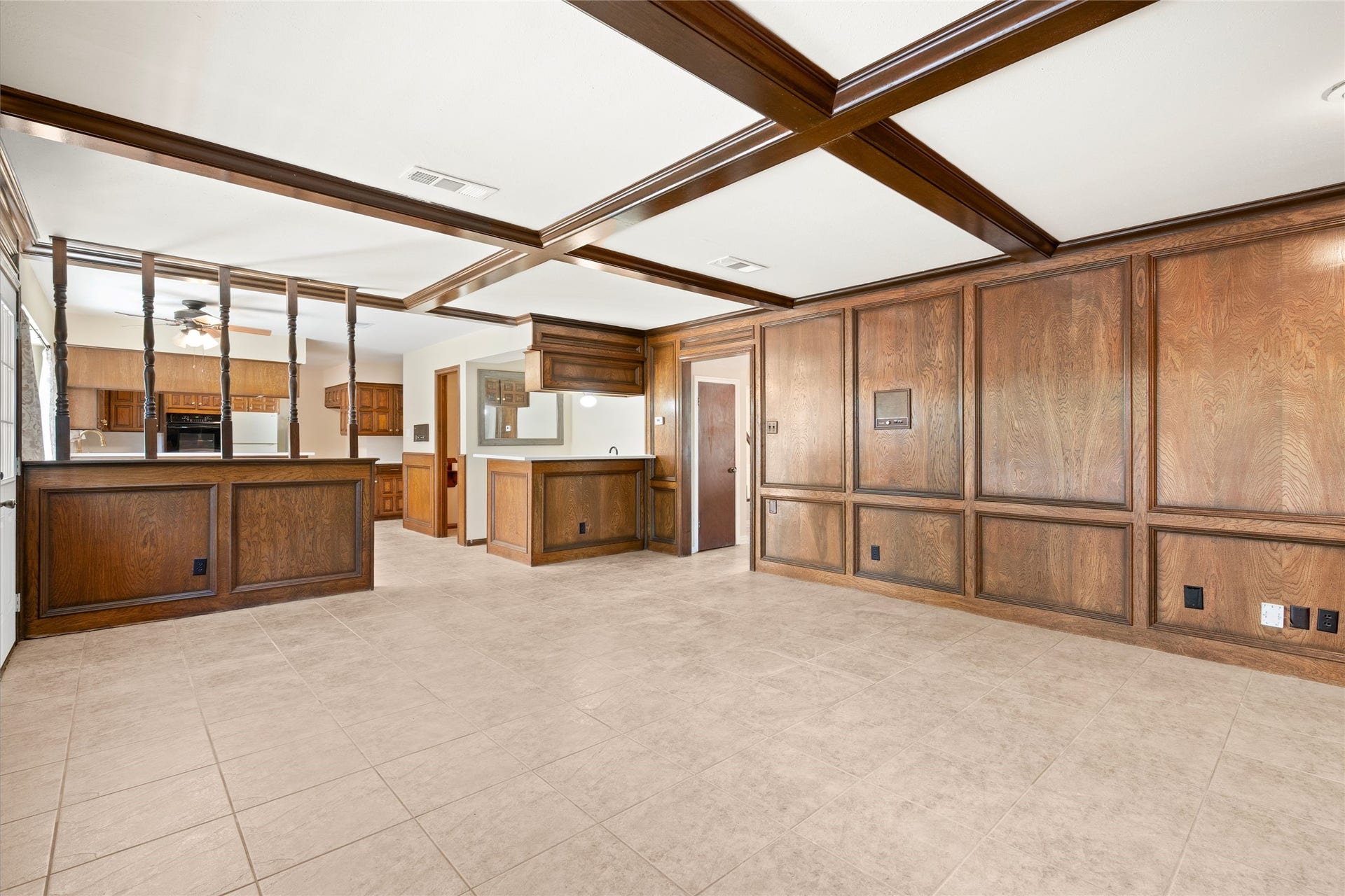 Another view of the family room that is open to the traditional wet bar and kitchen area.