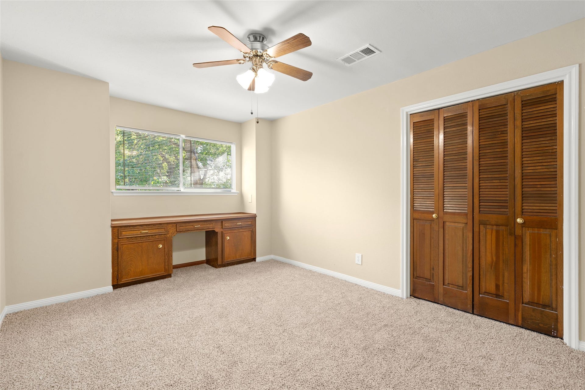 The 2nd and third bedrooms are larger than most new construction homes. This 2nd bedroom has a built in study desk or workspace.