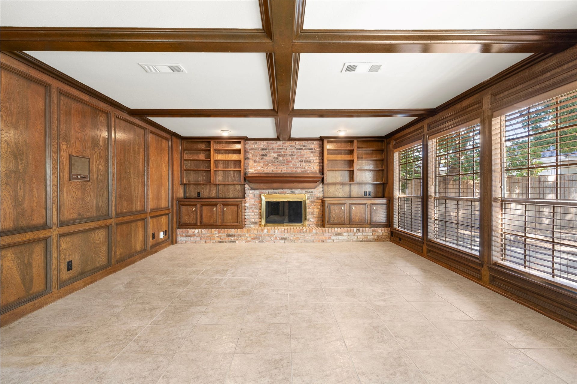 Rich wood beams accent the ceiling and present the brick hearth for a cozy feel.