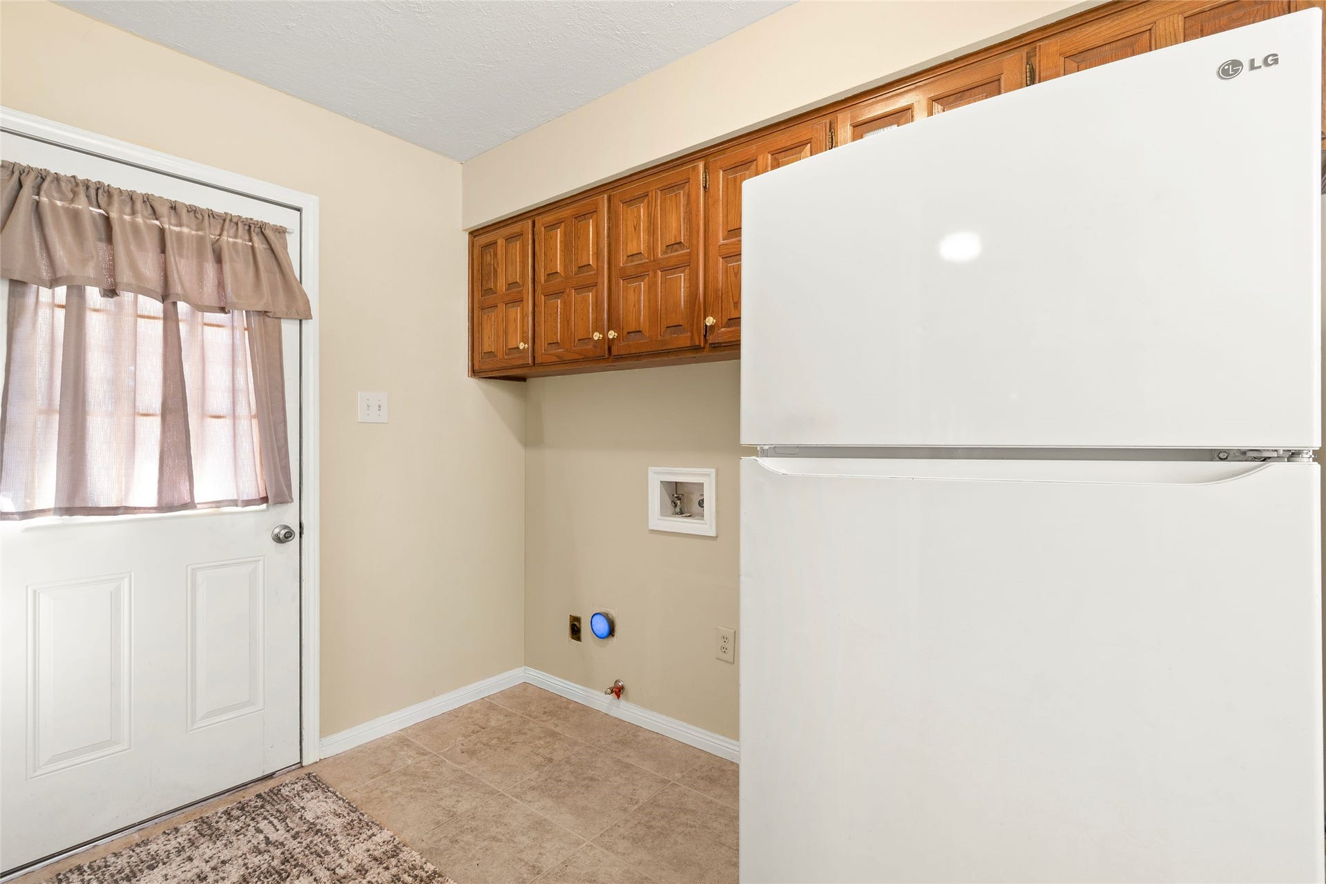 The laundry room is located just off the back patio and kitchen area.