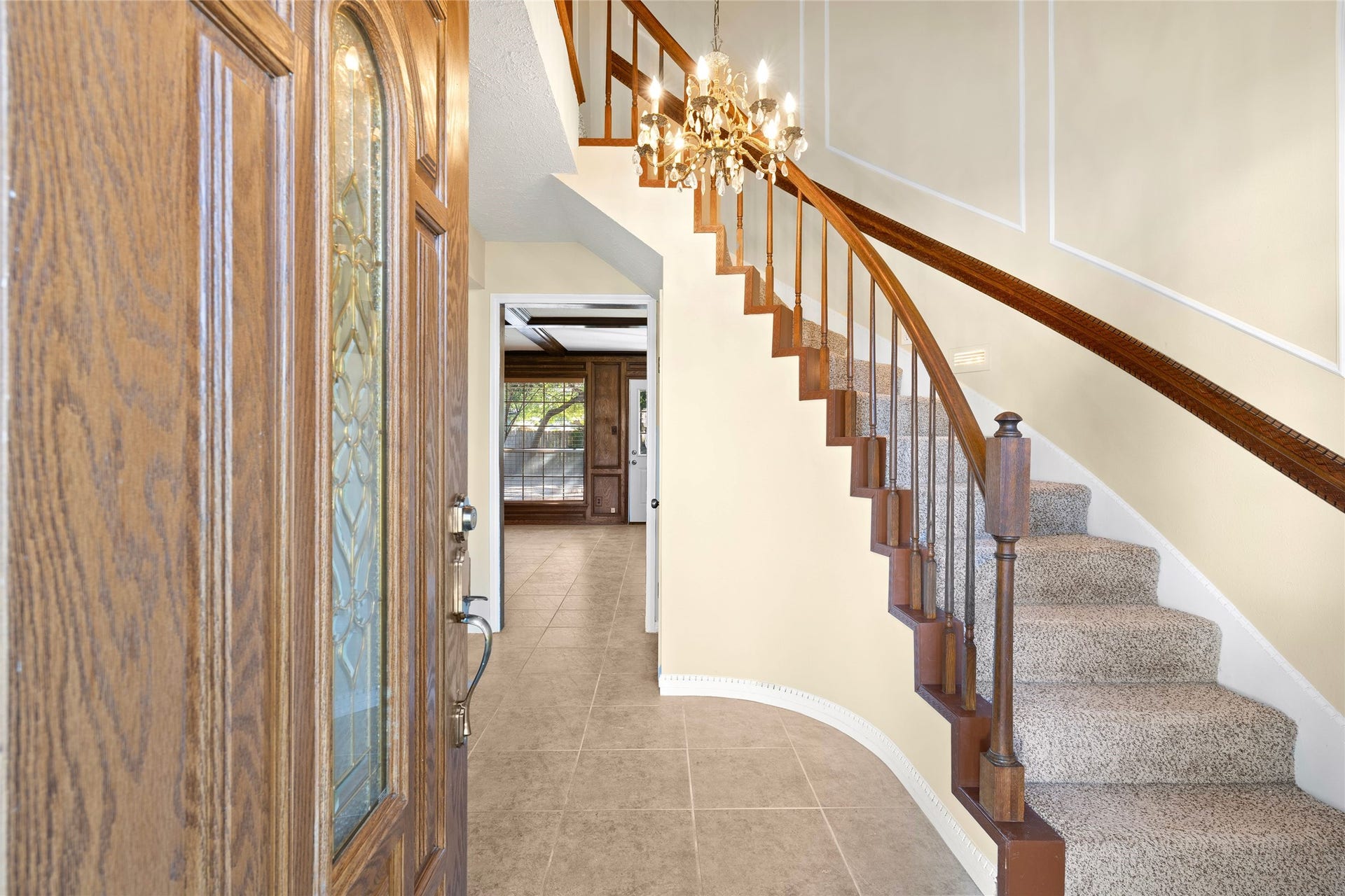 Elegant curved staircase greets you int he entryway when you enter this home.
