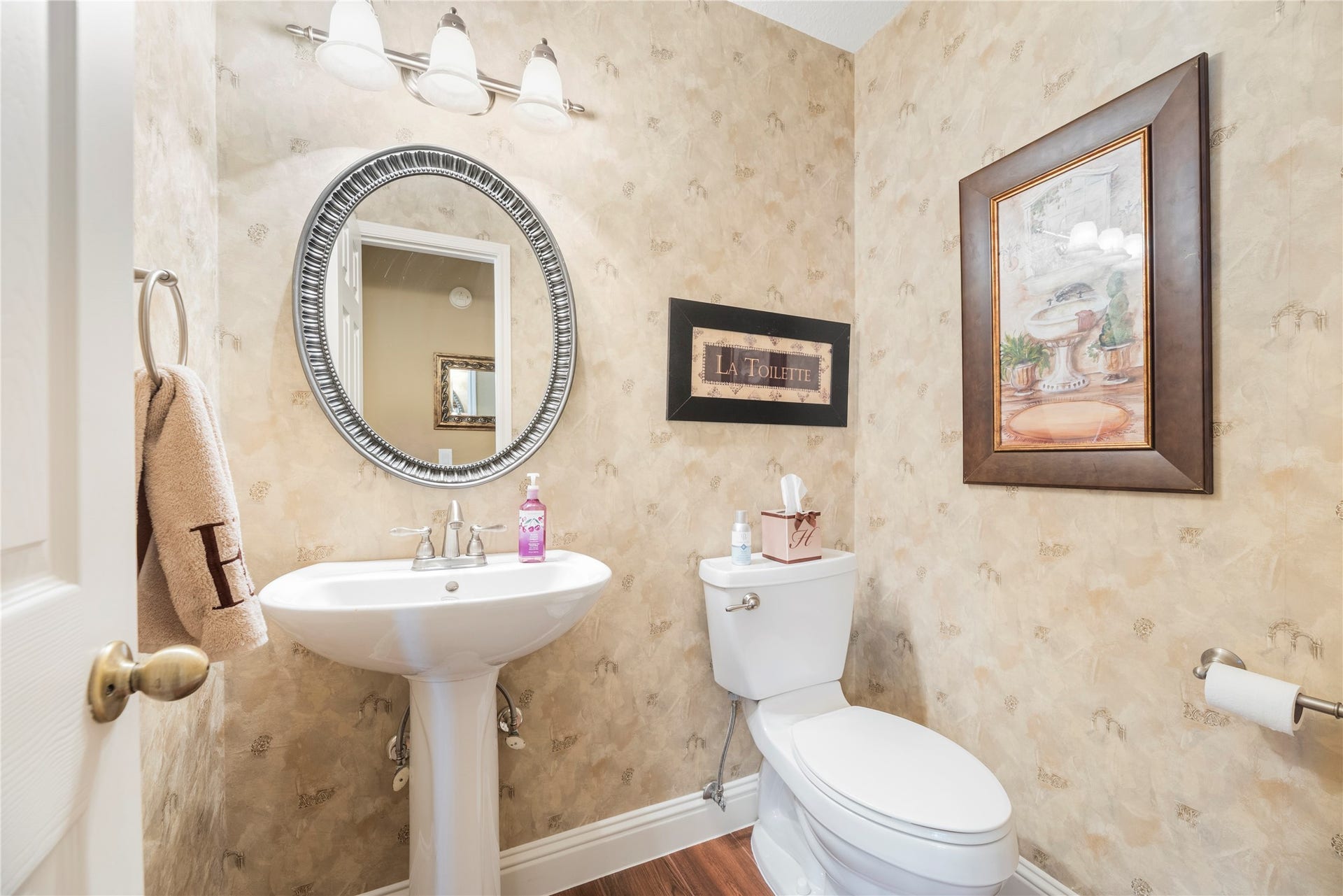 17906 Lone River Court, Houston, TX 77095 Convenient downstairs half bathroom with a pedestal sink.
