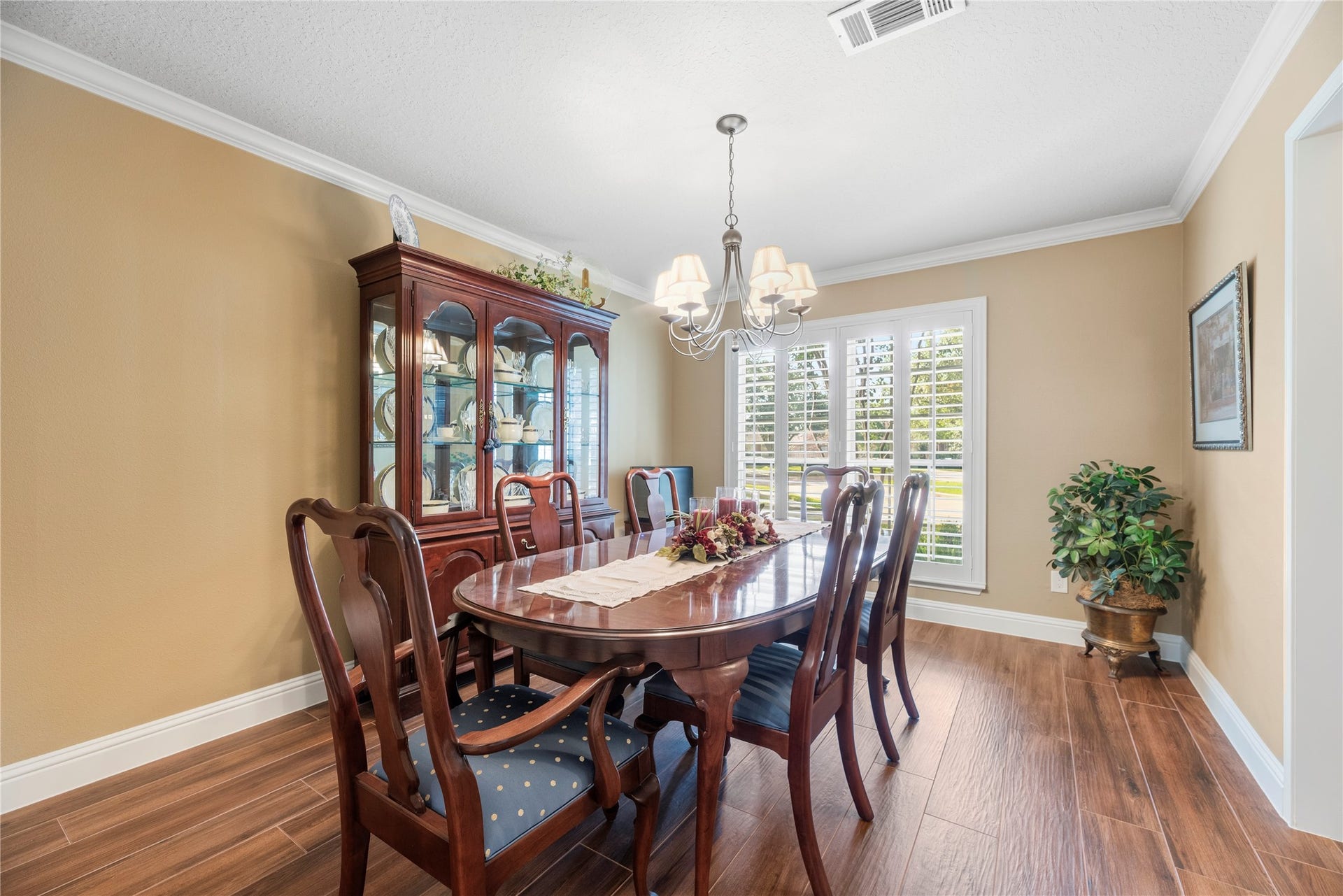 17906 Lone River Court, Houston, TX 77095 The formal dining room with crown molding, window shutters and wood-look tile flooring.