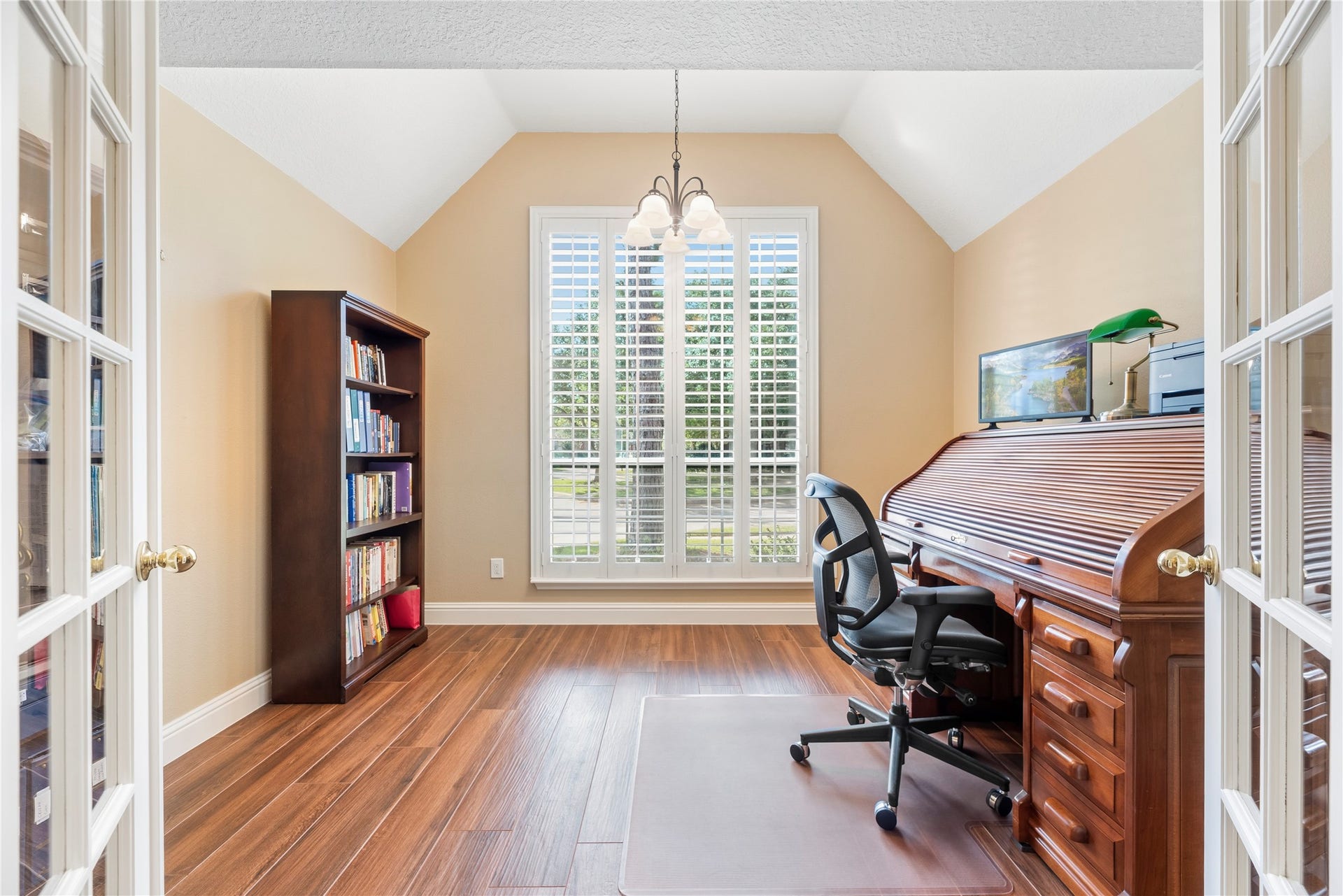 17906 Lone River Court, Houston, TX 77095 Home office features a high ceiling, window shutters, wood-look tile flooring and French doors for privacy.