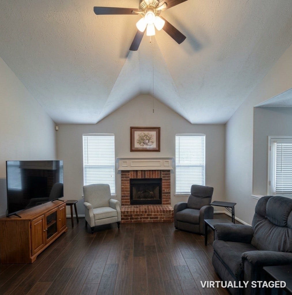15806 Laurel Cove, Tomball, TX 77377 Spacious family room featuring soaring ceilings, fresh Neutral paint, a new ceiling fan and cozy gas log fireplace
