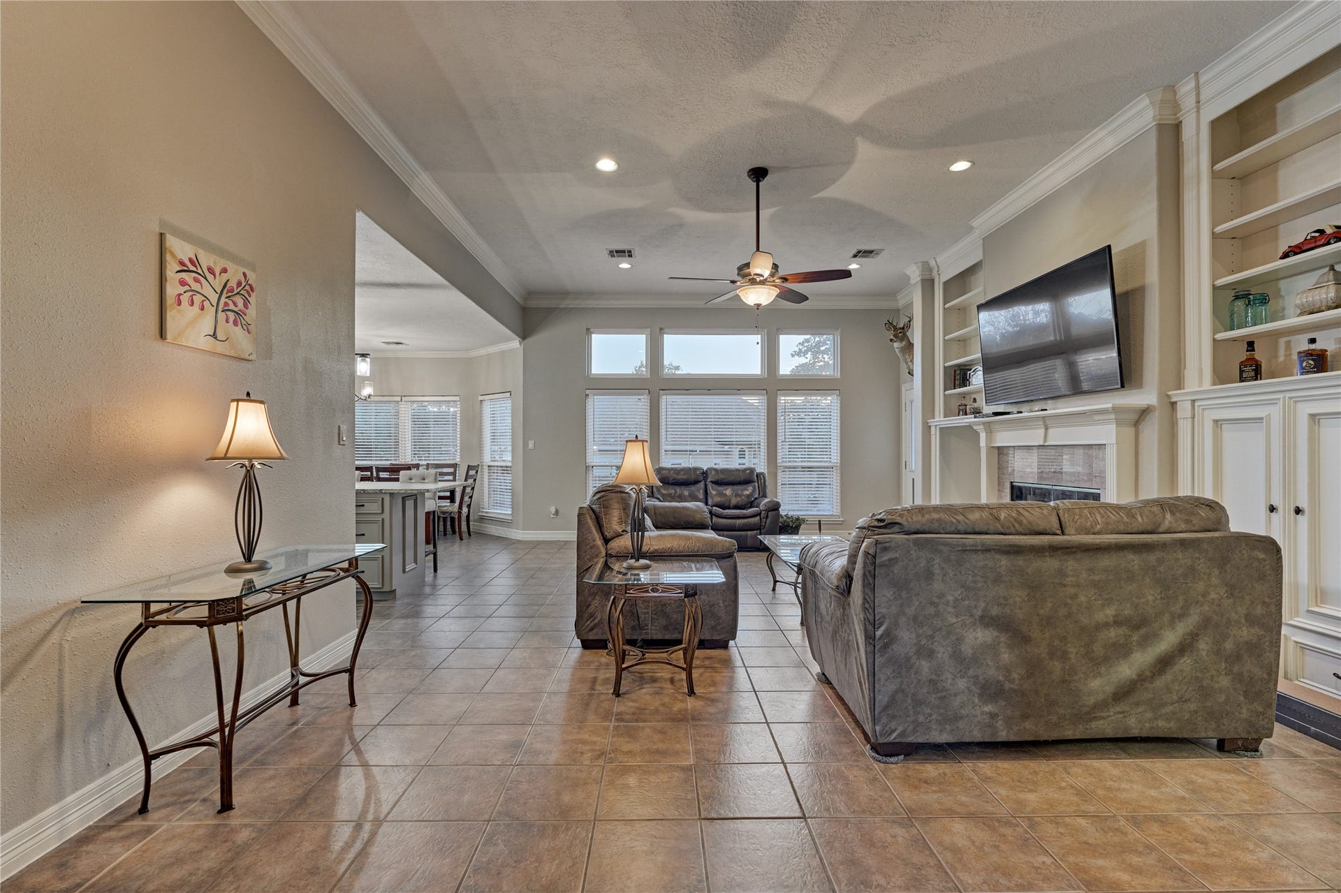 15 Newberry Court, Montgomery, TX 77356 Step into an open-concept floor plan filled with natural light, where an abundance of windows creates a bright, airy, and welcoming atmosphere throughout the space.