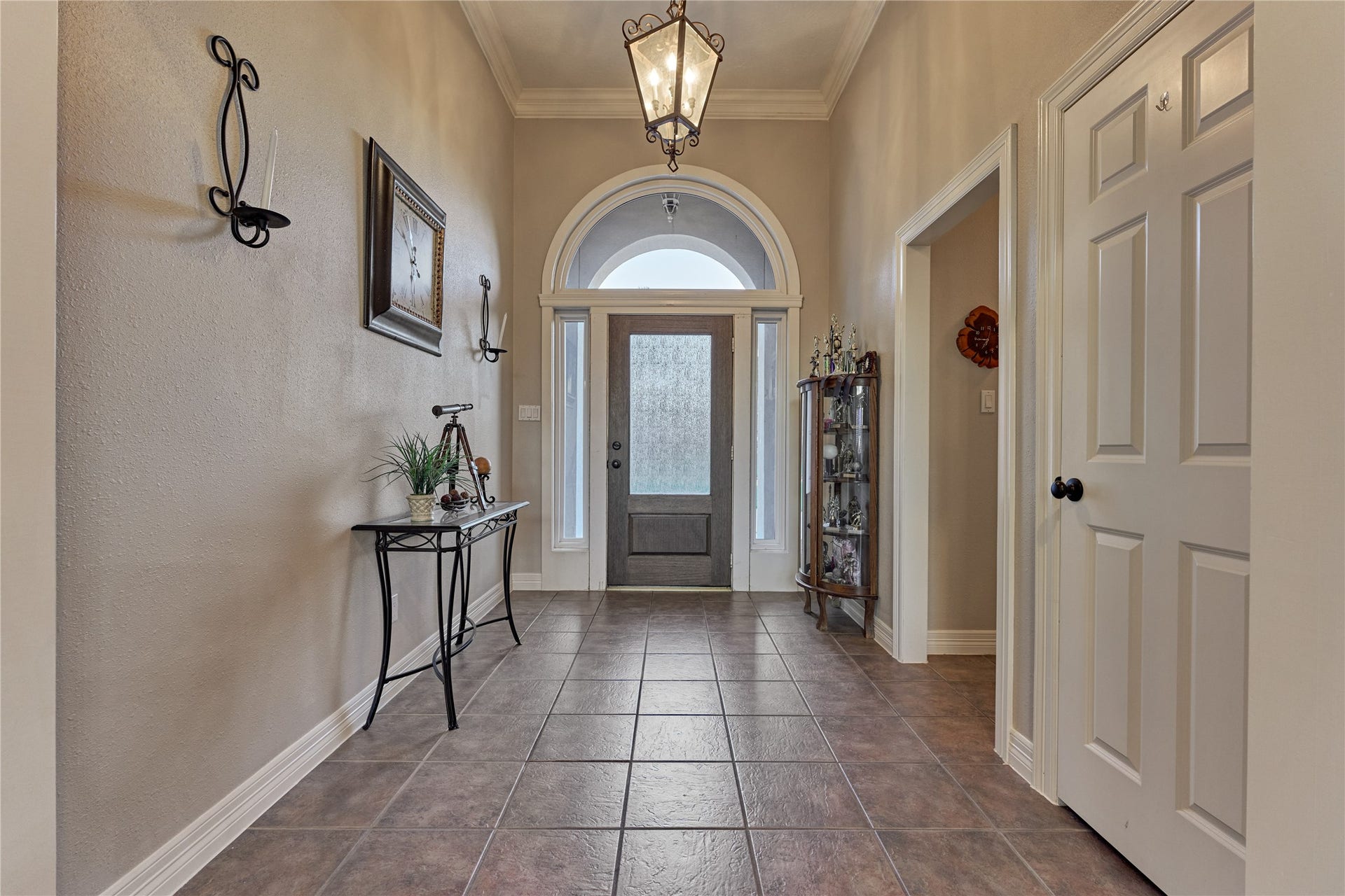 15 Newberry Court, Montgomery, TX 77356 An elegant arched transom window above the entry door adds architectural charm while filling the foyer with soft natural light.