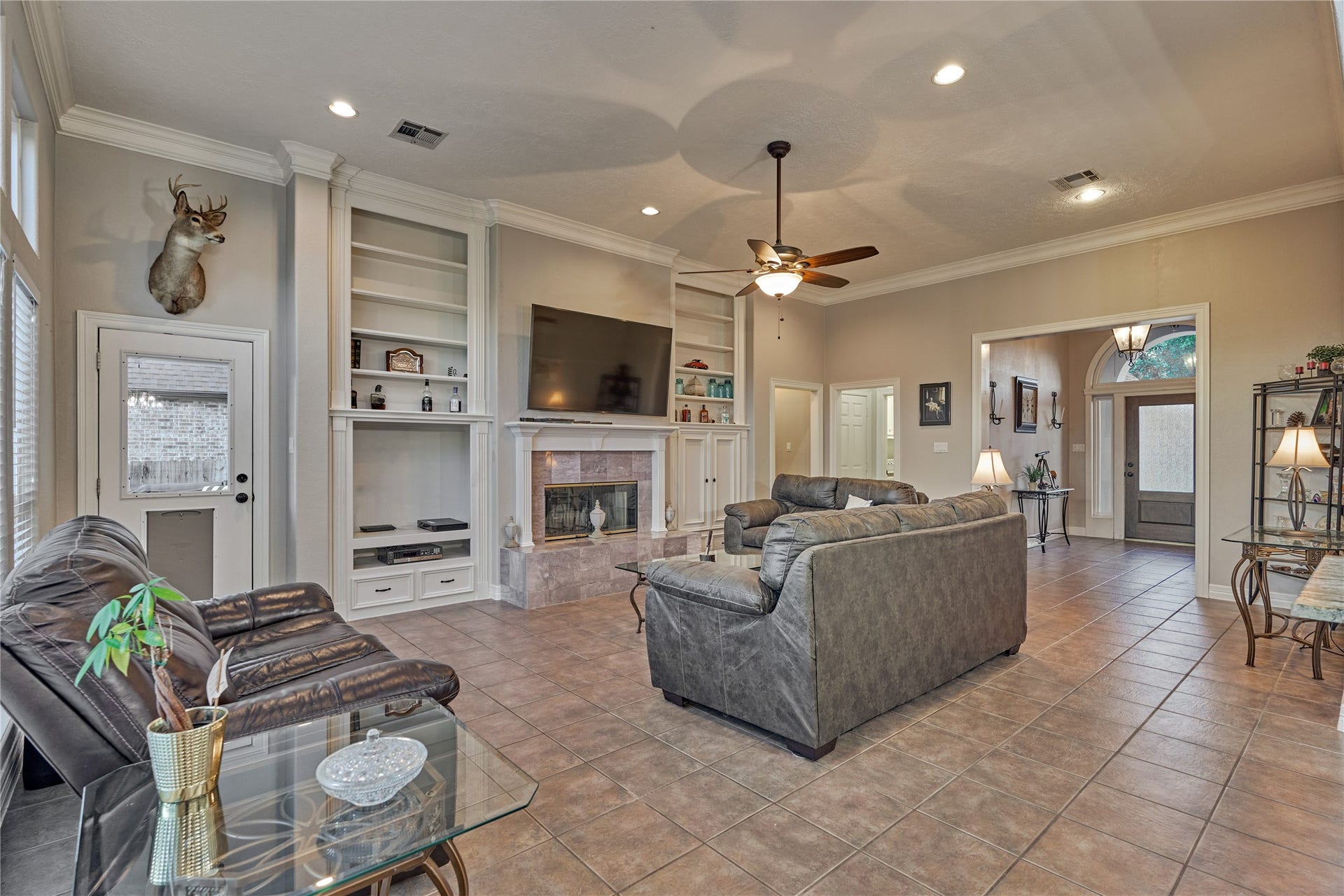 15 Newberry Court, Montgomery, TX 77356 A warm, inviting fireplace is beautifully flanked by custom built-in cabinetry, creating both a cozy focal point and stylish storage.