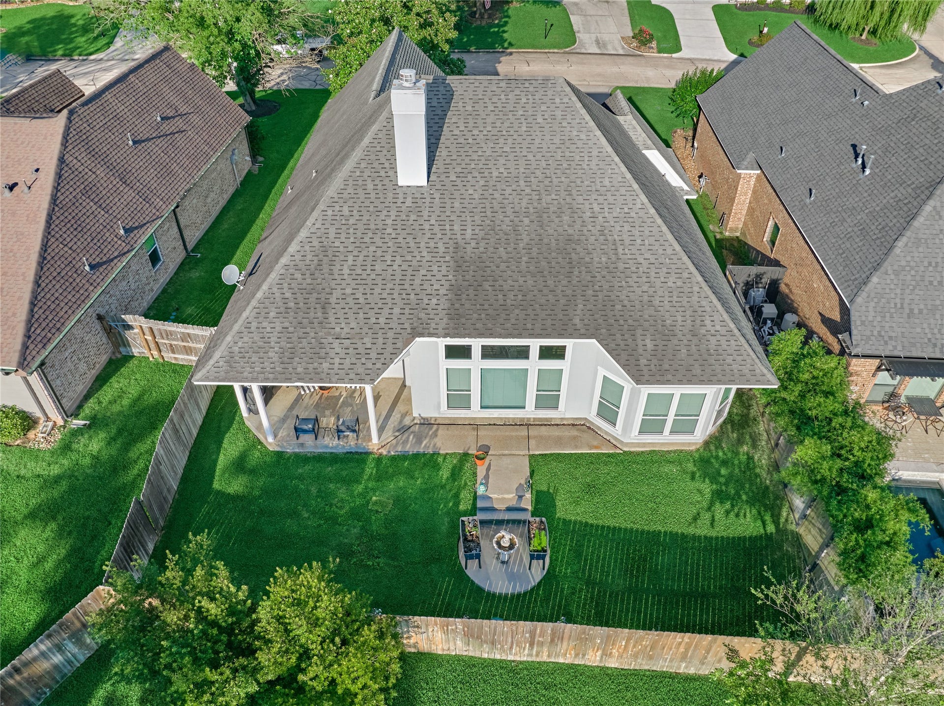 15 Newberry Court, Montgomery, TX 77356 Backyard retreat features a covered patio, perfect for relaxing and entertaining guests year-round.