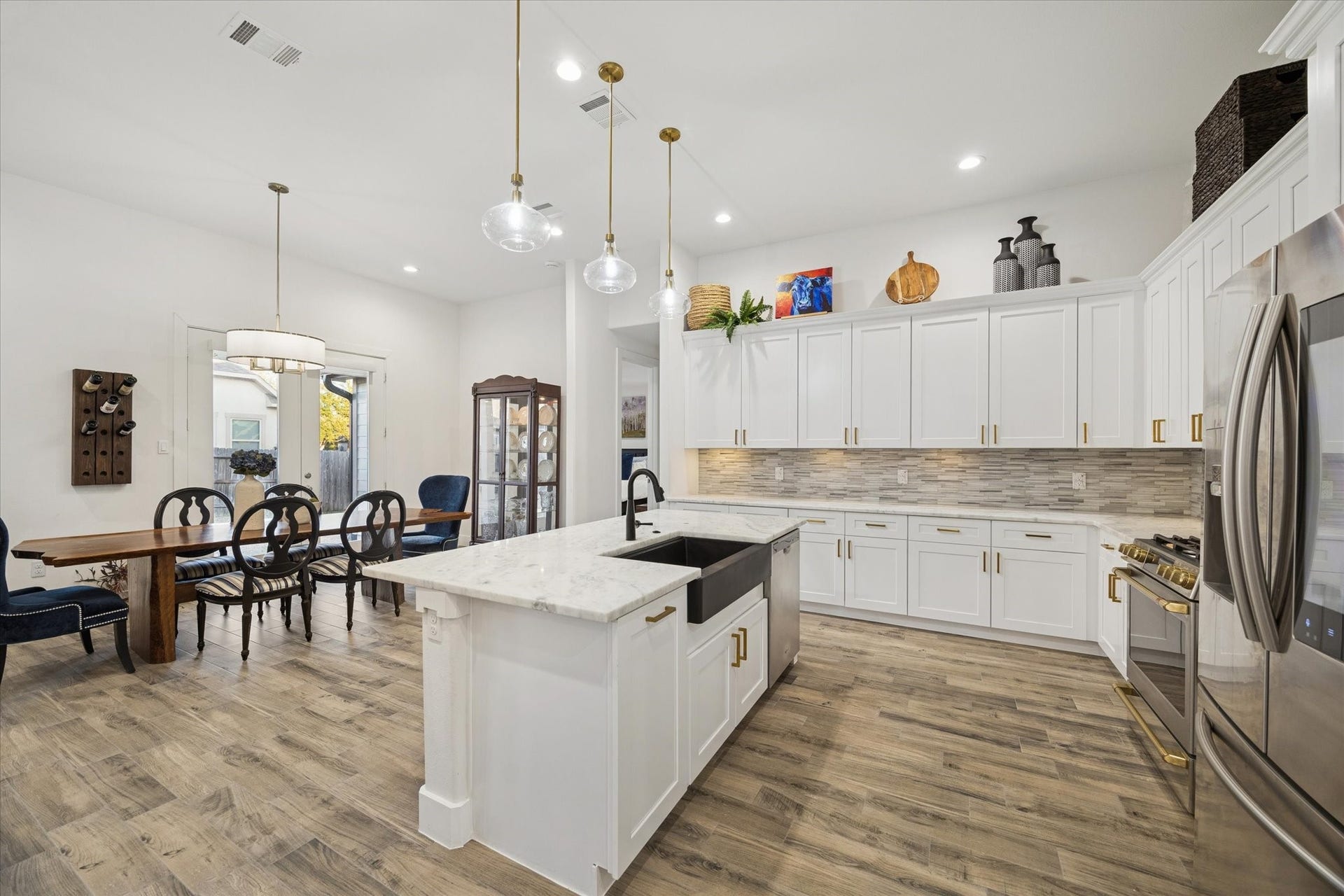 This angle highlights the kitchen from the left side, showcasing this truly unique and inviting space. Fully equipped and thoughtfully designed, its ready for you and your family to start enjoying this beautiful home. The kitchen inspires creativity, making it the perfect place to explore new recipes and make the most of every element in this space.