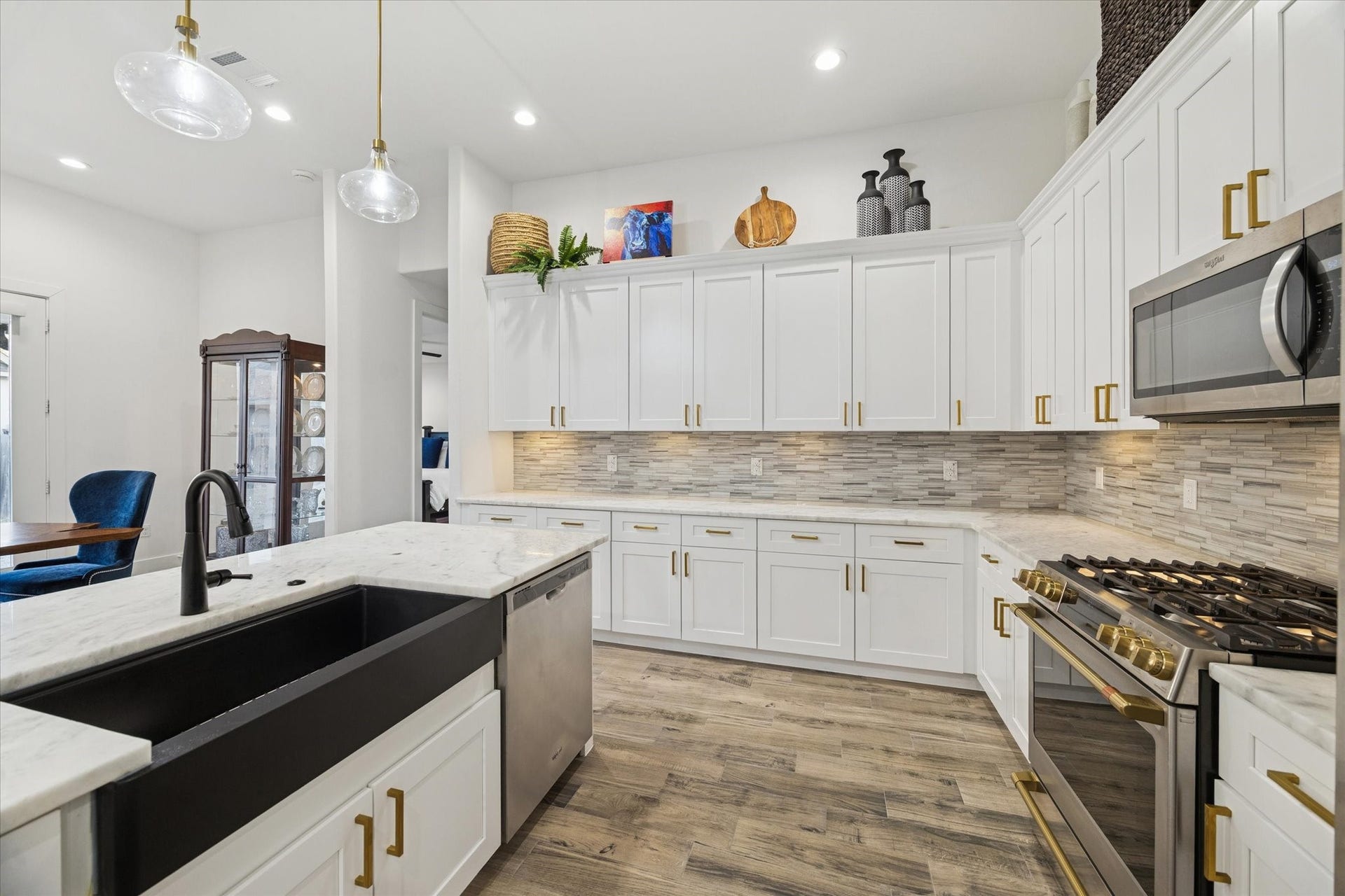 This close-up angle highlights the deep and spacious farmhouse sink, emphasizing both comfort and functionality. This kitchen inspires confidence in cooking, even for those less experienced, encouraging you to prepare meals and enjoy your coffee daily in a space designed for both style and practicality.