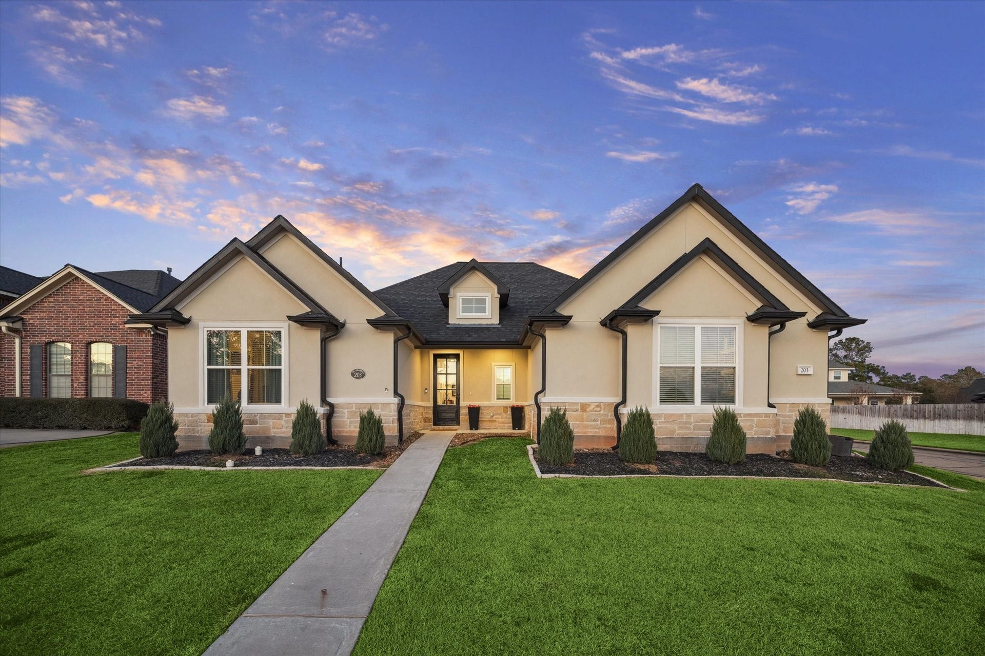 This beautiful corner-lot home offers exceptional curb appeal, featuring an elegant stone and stucco exterior, a harmonious color palette, and well-maintained landscaping that creates a warm and inviting first impression.