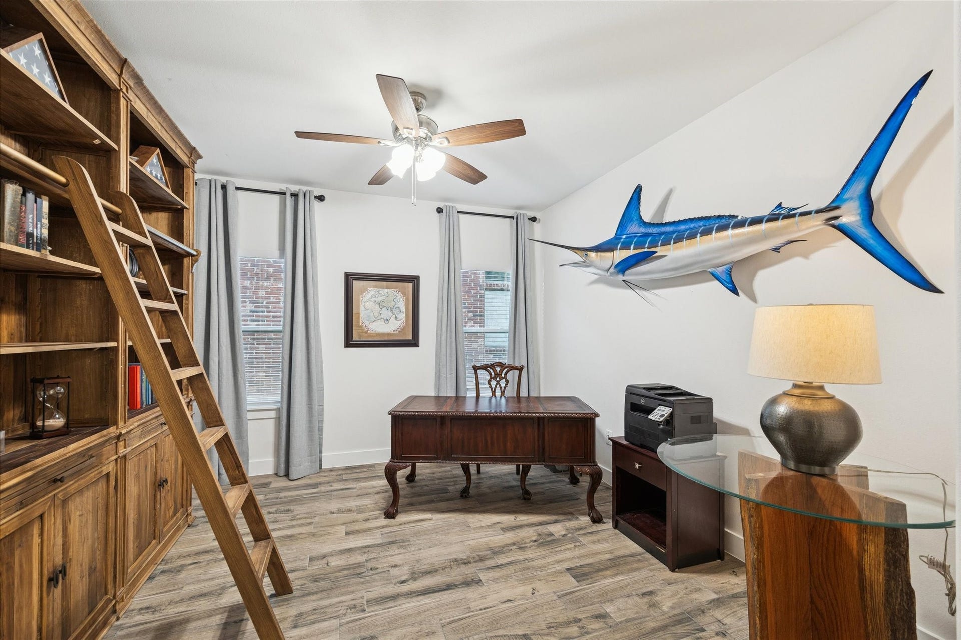 This secondary bedroom currently used as a home office is spacious and filled with abundant natural light from the large windows. The soft, light wall colors create a sense of calm and harmony, making this room a bright and inviting retreat.
