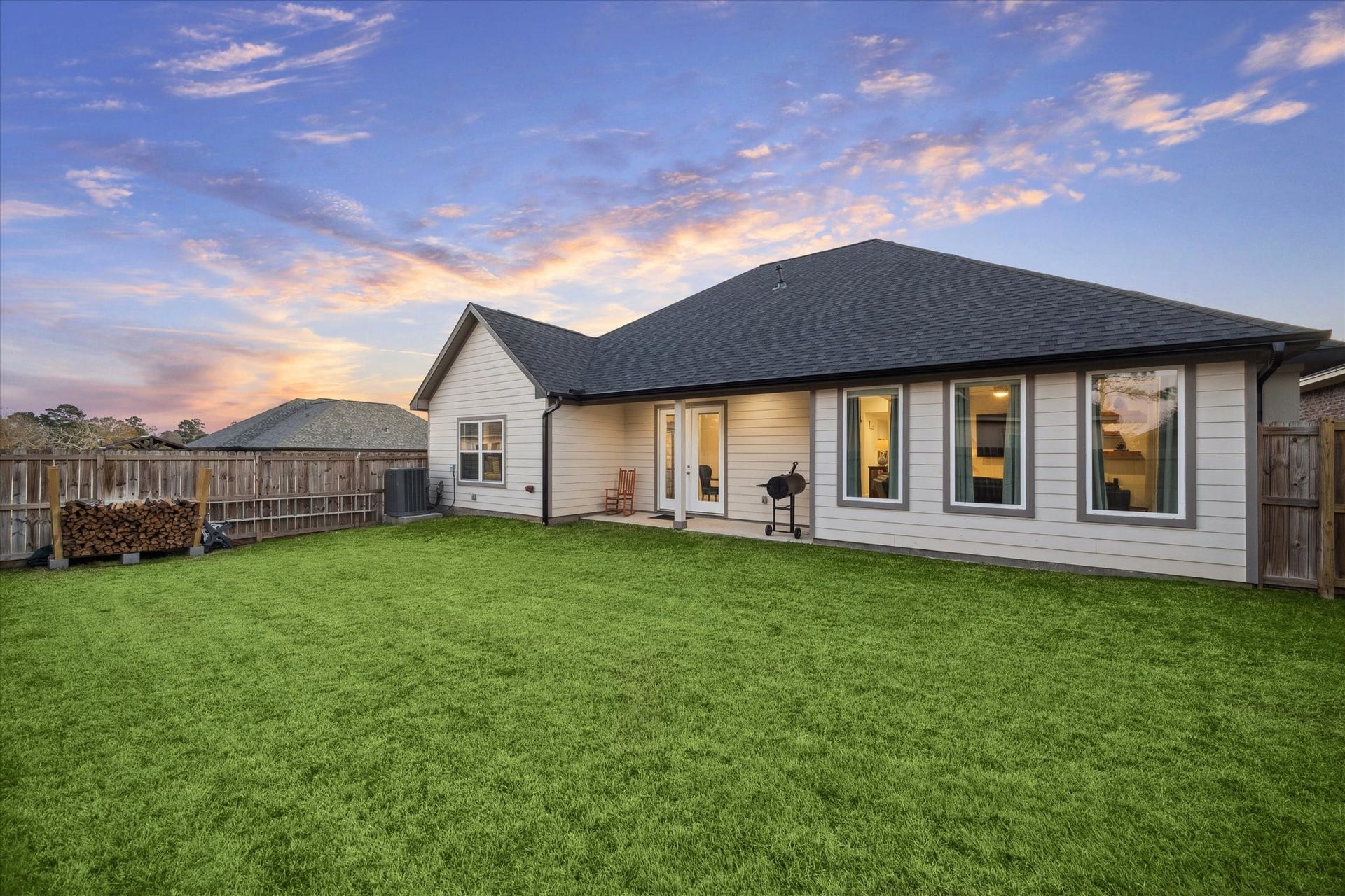 This angle of the right side of the patio highlights the corner-lot location, offering both privacy and convenience. The garage is positioned with access to the side street, providing ease for residents and guests.