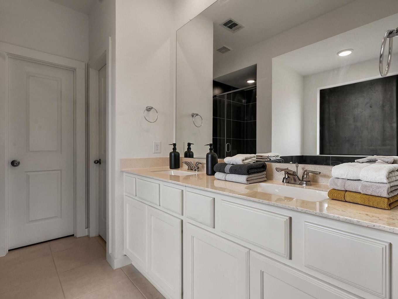 13021 Sapphire Lake Lane, La Marque, TX 77568 The primary bath features double sinks, bright counters, and clean cabinetry. A fresh ensuite space with a crisp, polished finish. Virtually staged.