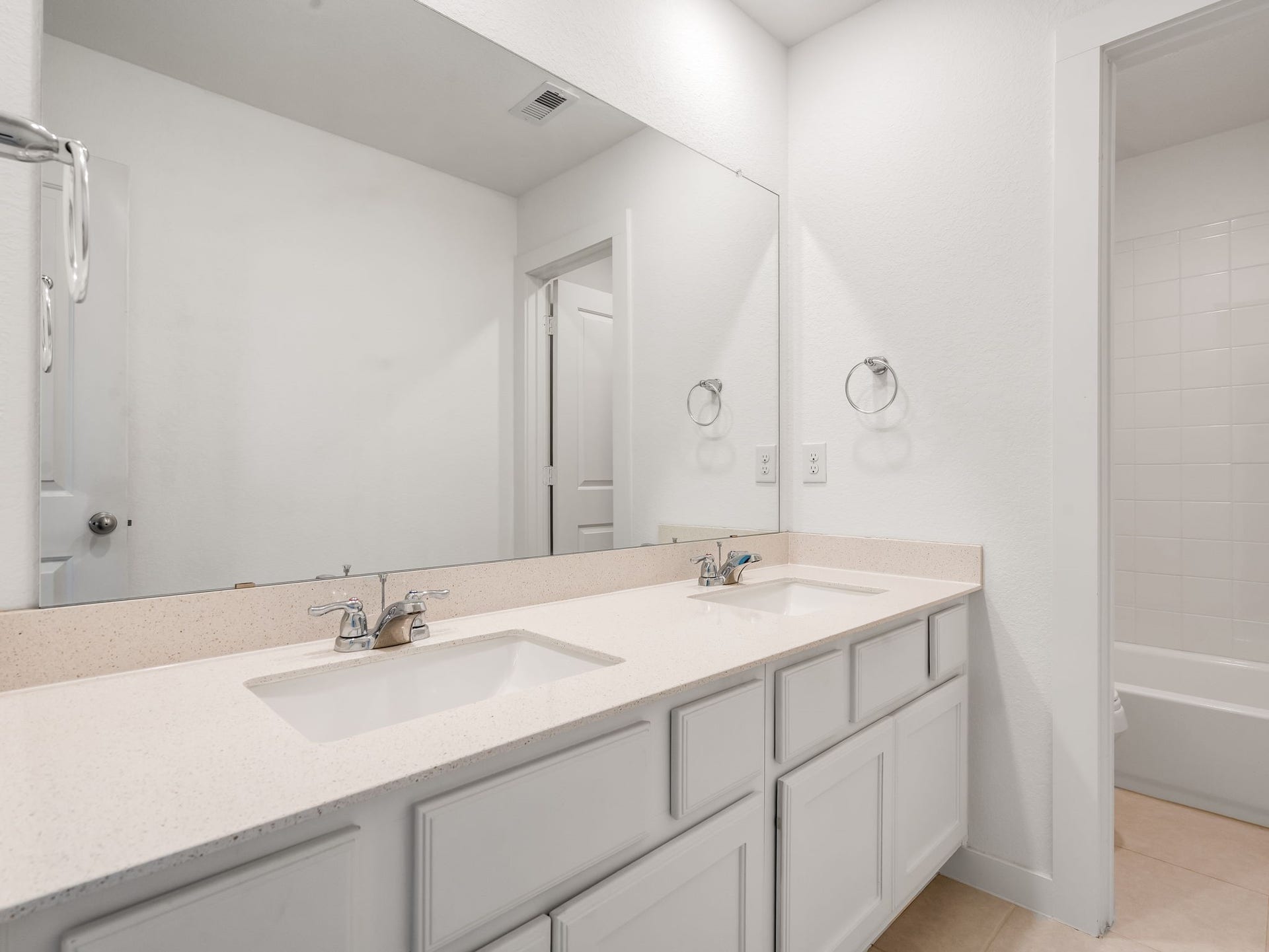 13021 Sapphire Lake Lane, La Marque, TX 77568 The bathroom vanity brings bright counters, clean cabinetry, and a simple mirror detail together. A crisp everyday bath finish. Virtually staged.