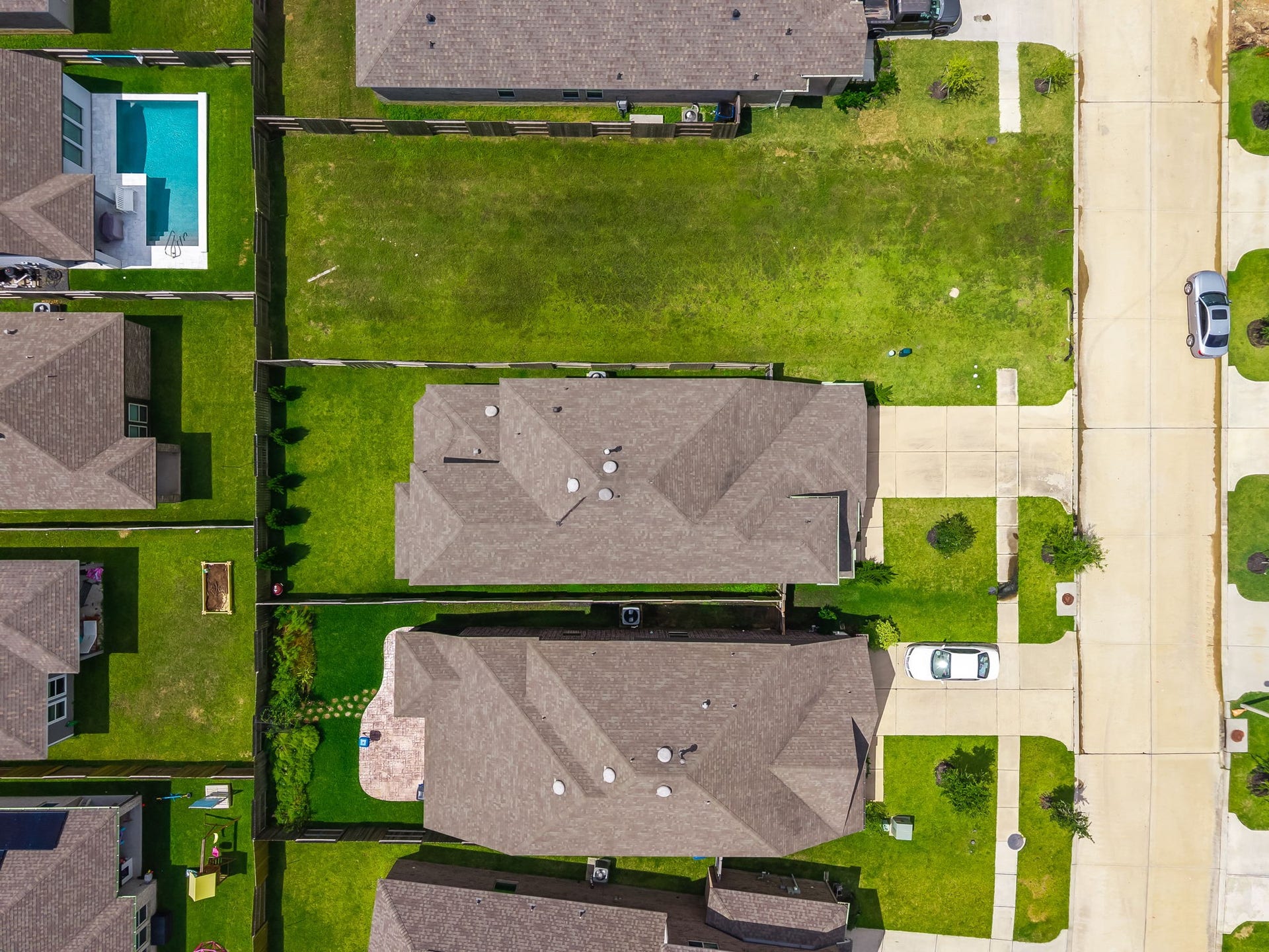13021 Sapphire Lake Lane, La Marque, TX 77568 The overhead view highlights the homes roofline, driveway, backyard, and lot placement within Lago Mar. A clear look at the propertys setting. Virtually staged.
