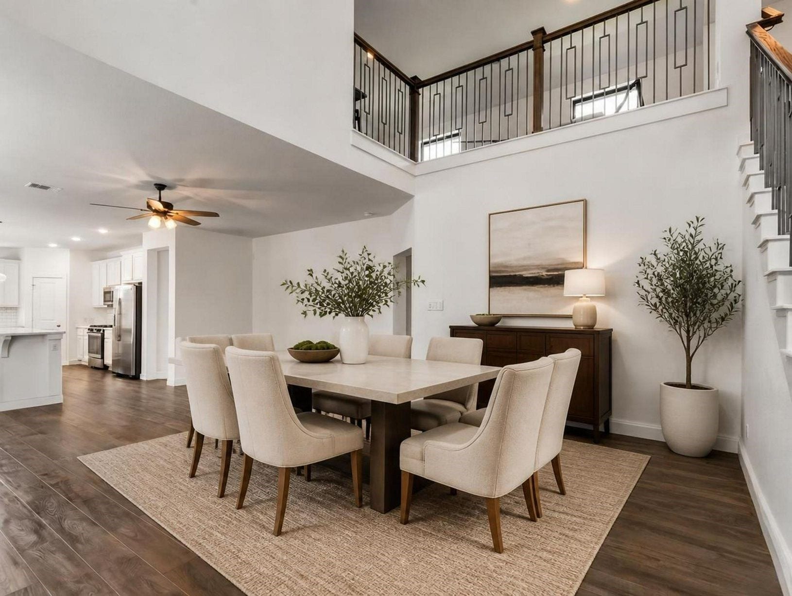 13021 Sapphire Lake Lane, La Marque, TX 77568 The dining area sits beautifully beneath the staircase, giving the main level a defined place to gather. Clean lines and soft finishes make the space feel polished. Virtually staged.