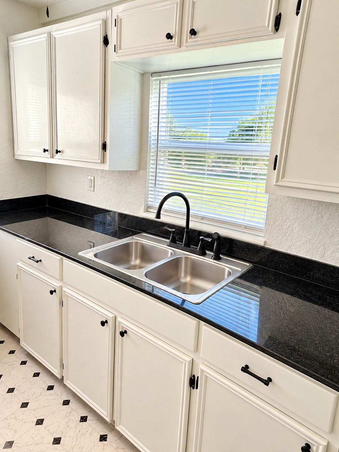 109 N Avenue A Avenue, Freeport, TX 77541 Freshly updated kitchen featuring beautiful granite countertops, a sleek modern faucet, and a brand-new stove, offering both style and functionality