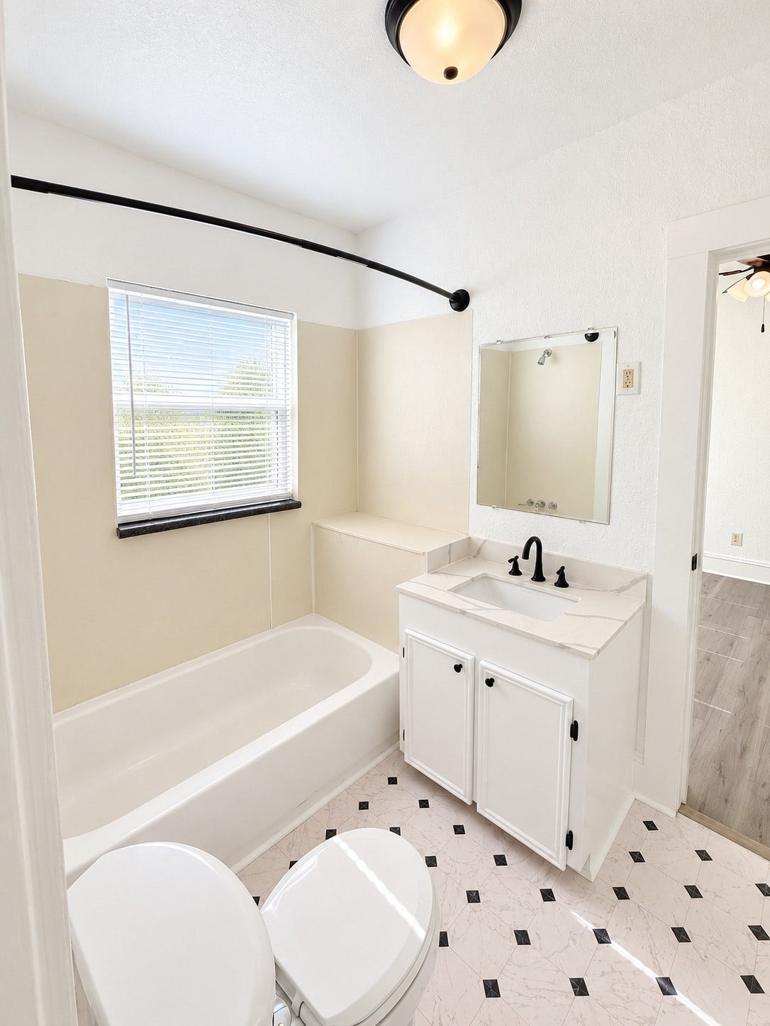 109 N Avenue A Avenue, Freeport, TX 77541 Conveniently located bathroom with direct access from both bedrooms, offering a functional Jack-and-Jill layout